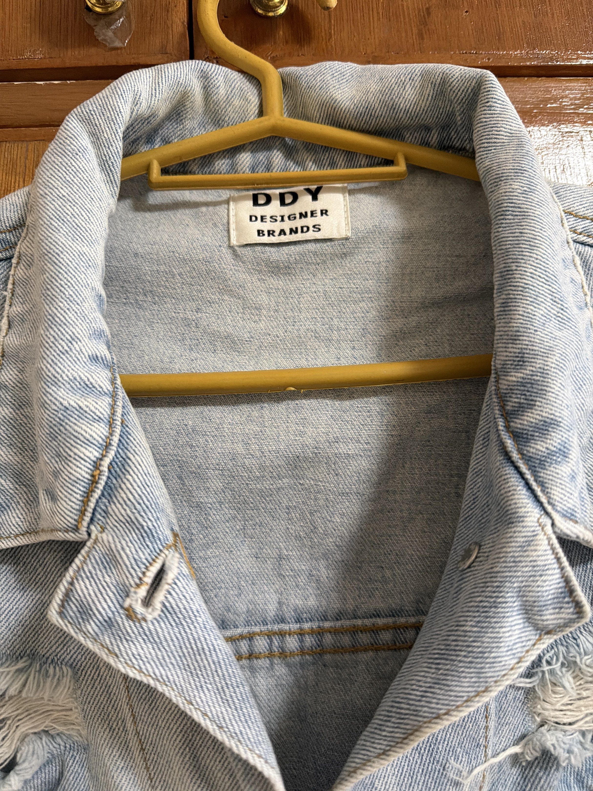 Oversized Denim Jacket (Category: Coats, Jackets and Outerwear) located in Manila. Submitted by dmdnice (Listing ID 1419440340, Image 2). Description: - DDY Designer Brands denim jacket - Light blue color - Distressed design with ripped details - Two chest pockets - Button closures - Classic collar - Relaxed fit - Perfect for layering.