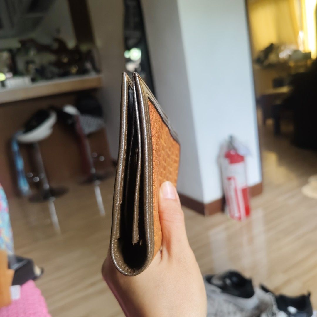 Pierre Balmain Orange Wallet (Category: Luxury Bags & Wallets) located in Danao, Cebu. Submitted by anne_2016143 (Listing ID 1419447406, Image 2). Description: - Pierre Balmain wallet - Orange patterned exterior with brown trim - Features a gold-tone clasp - Brown interior with multiple compartments - Brand name visible inside - Made in Spain.