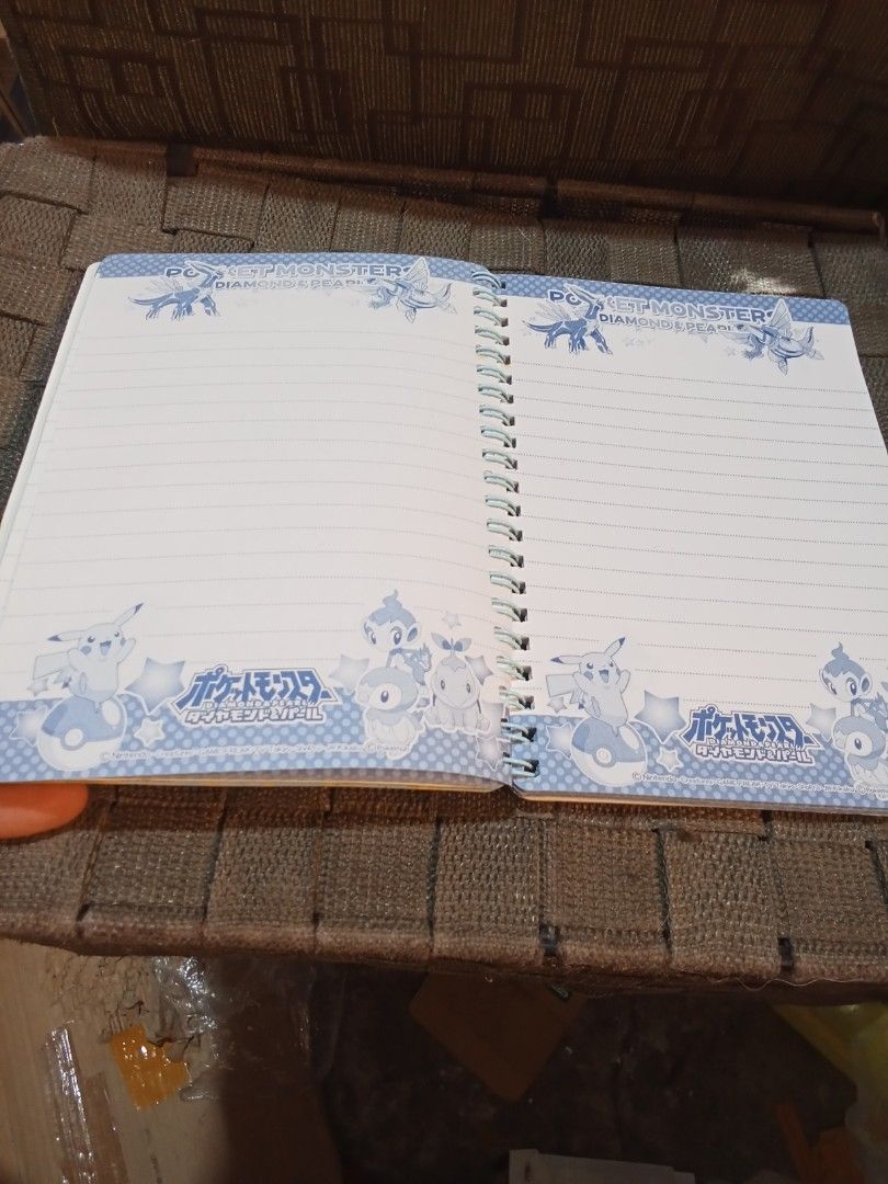Pokemon Diamond & Pearl Spiral Notebook (Category: Stationery & School Supplies) located in Bocaue. Submitted by marajapansurplus (Listing ID 1419408818, Image 2). Description: - Pokemon Diamond & Pearl themed notebook. - Features a vibrant cover with Pokemon characters. - Lined pages with decorative Pokemon borders. - Ideal for notes, sketches, or journaling. - Compact and easy to carry..