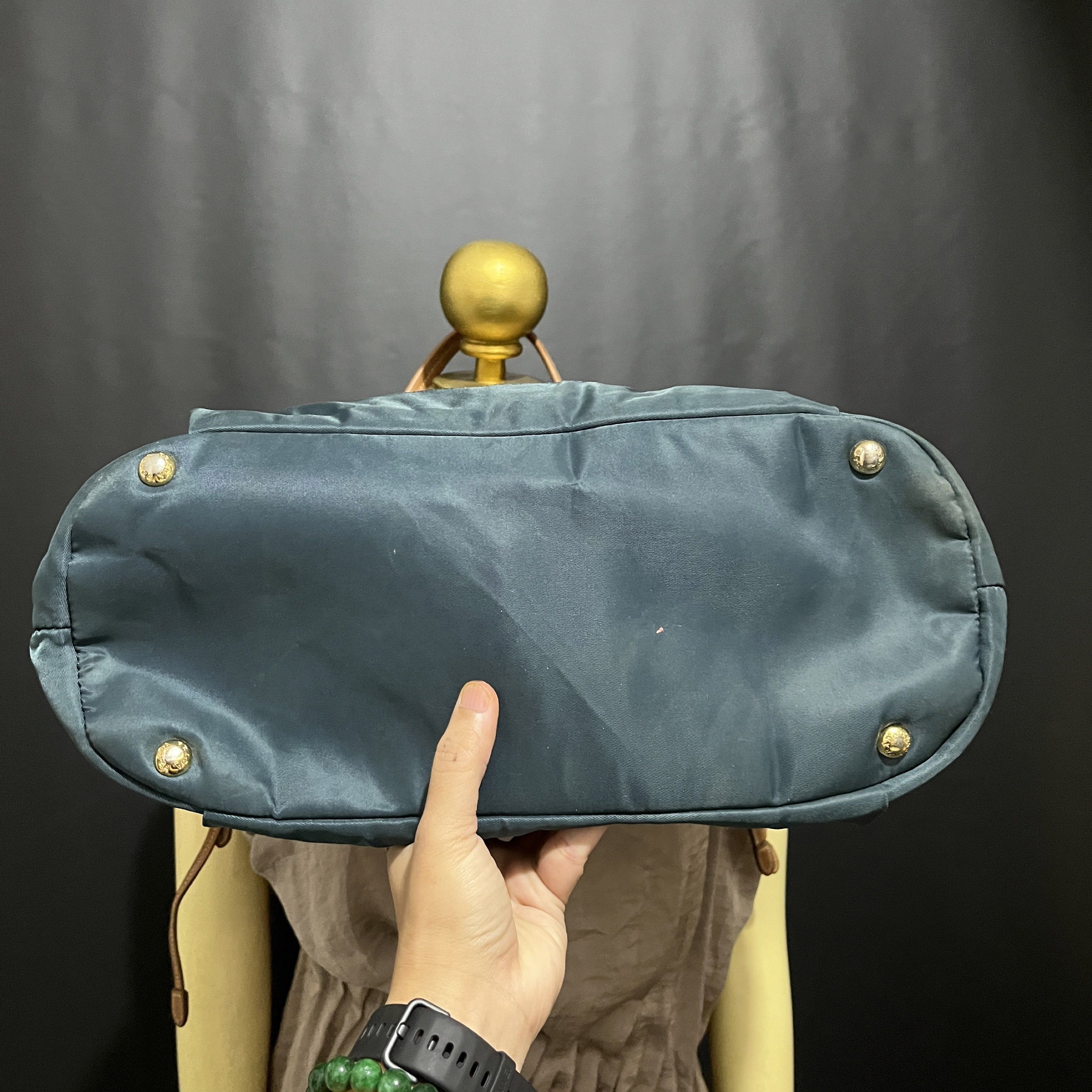 Prada Drawstring Tote Bag (Category: Luxury Bags & Wallets) located in Butuan. Submitted by dfgthriftology2.0 (Listing ID 1419544662, Image 3). Description: - Teal nylon exterior - Leather handles - Drawstring closure - Prada logo embroidery - Interior zipper pocket - Leather tag with Prada logo - Gold-tone hardware.