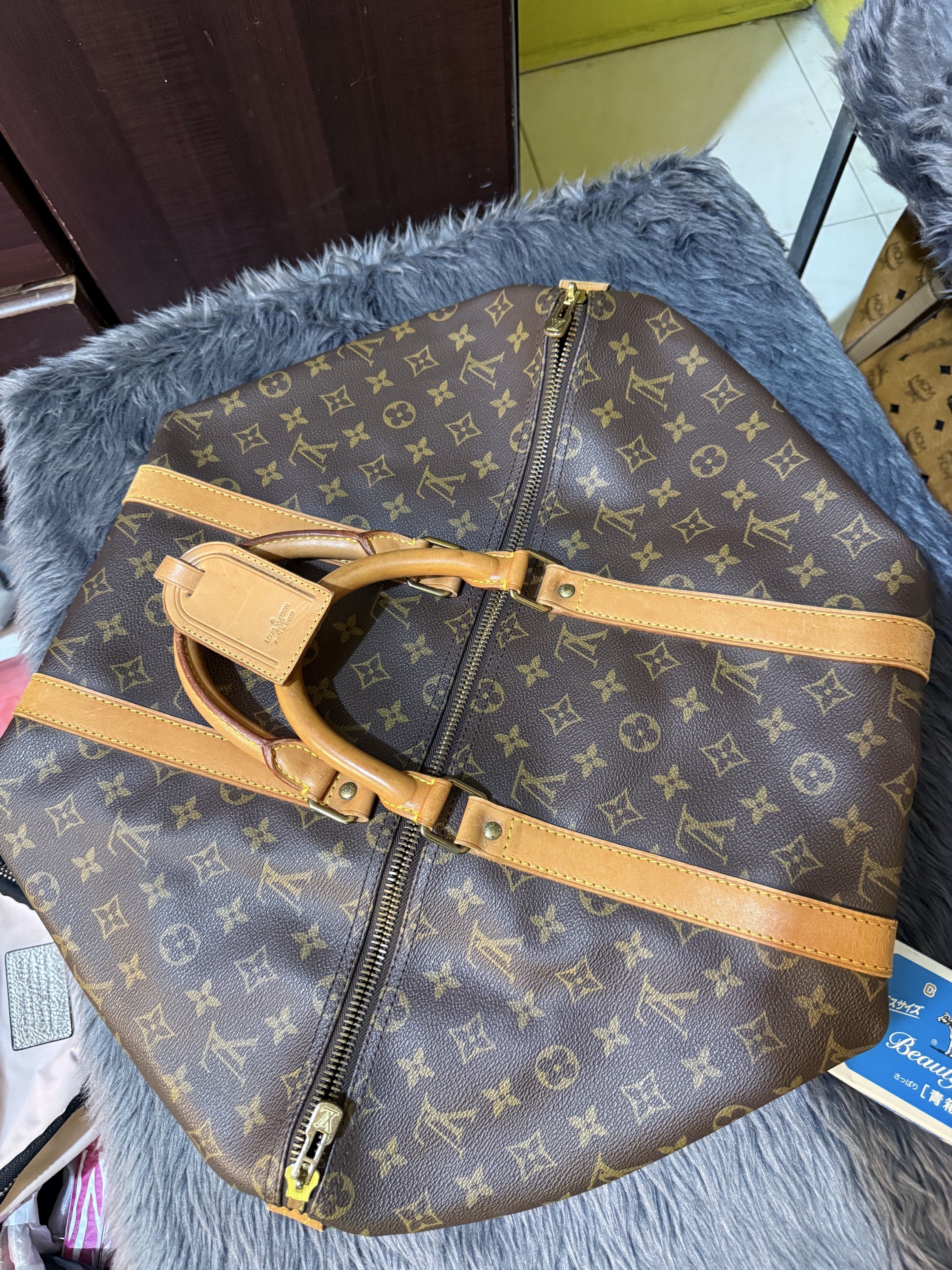 Sale‼️ Preloved LV Keepall 50cm (Category: Luxury Bags & Wallets) located in Cavite. Submitted by nigella02 (Listing ID 1414990961, Image 2). Description: Preloved Original Keepall 50cm Rank A Condition Honey patina, shows signs of usage at a minimum Guaranteed Original. Bought in Japan. All corners in tact. Handwriting in the inner lining. Ideal For travel. .
