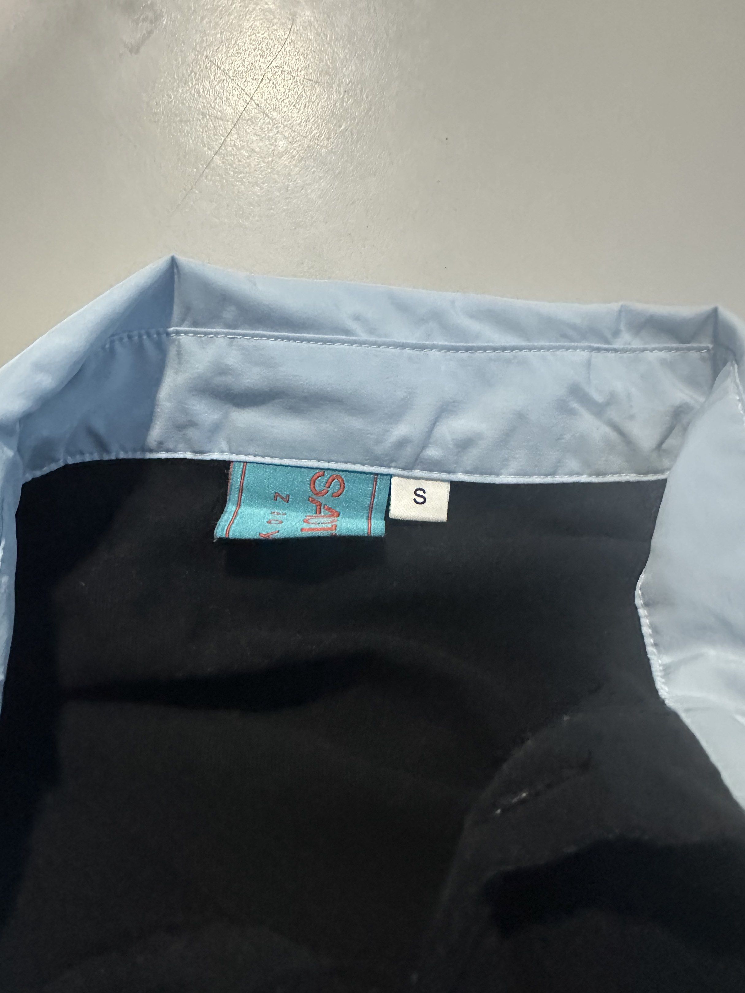 Saotome Polo Shirt - Size S (Category: Tshirts & Polo Shirts ) located in Manila. Submitted by 143aly (Listing ID 1419396137, Image 3). Description: - Saotome polo shirt - Color: Black body with light blue collar and accents - Size: Small but can fit to medium to large - Design: Button-down - Features: Small Saotome logo on chest.
