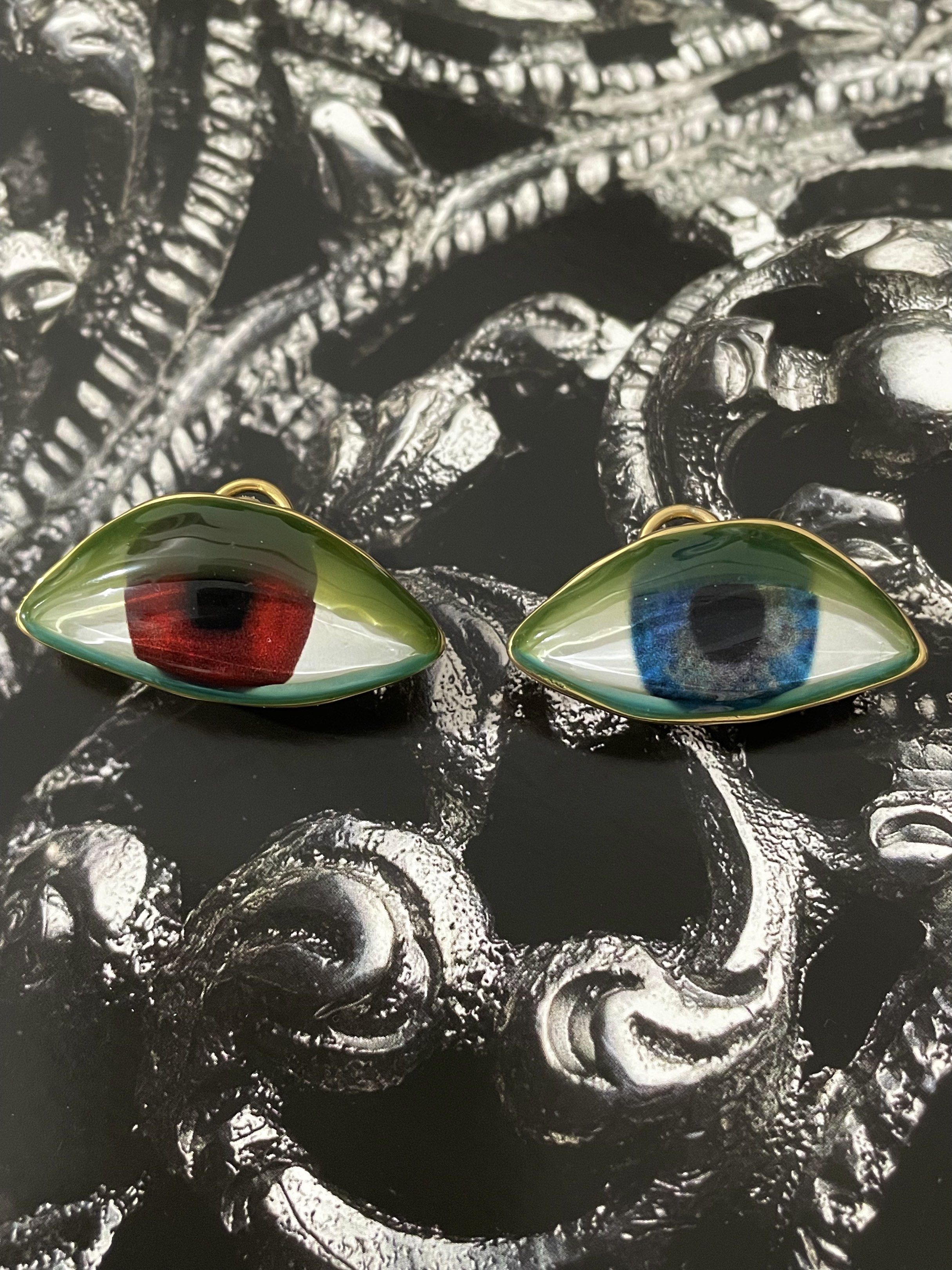 Schiaparelli Eye Earrings (Category: Earrings) located in Pasig City. Submitted by Jo.JewelsofVVM (Listing ID 1419585695, Image 2). Description: This unique pair pays homage to one of the designer house’s iconic codes. The mismatched color of the eyes (red and blue) with lids in green and blue transparent enamels offering a 3D like effect, like a statement wearable art set in soft gold plated metal and hallmarked with the designer’s signature. Un