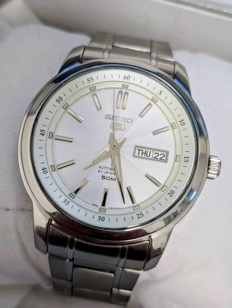 Seiko 5 Automatic 21 Jewel Watch (Category: Accessory Holder, Box & Organizers) located in Pasig City. Submitted by agatha.co (Listing ID 1419478123, Image 1). Description: ‼️ FOR SALE ‼️ Seiko 5 Automatic 21 Jewel Watch Reference: SNKM83K1 [Texture Silver dial] ✅ Inclusions: Watch and Replacement box ✅ Pre-owned condition (9/10) ✅ Open back case 📌 Note: This timepiece is pre-owned and carries its own distinctive charm..
