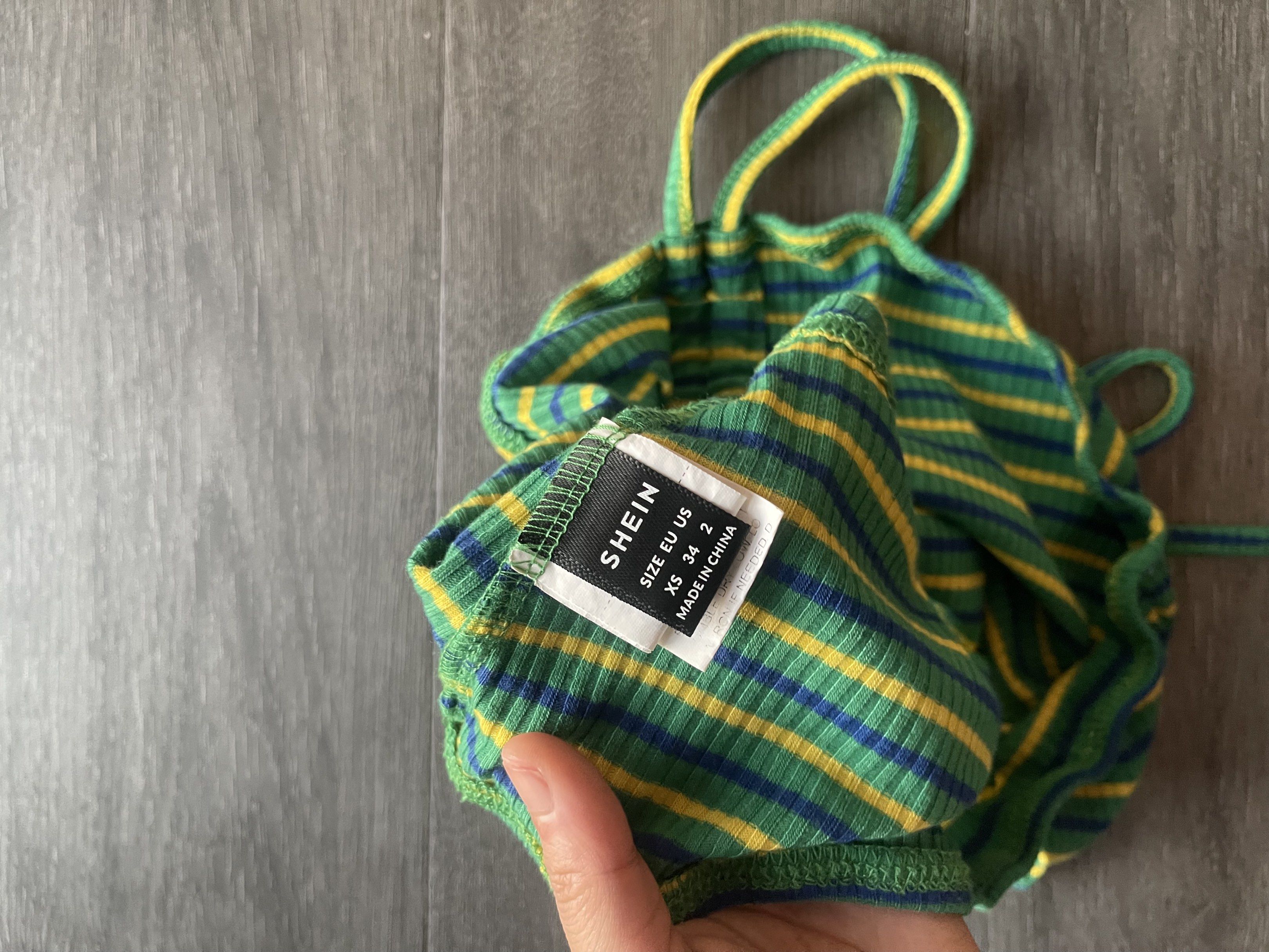 Shein Striped Tube Top (Category: Sleeveless) located in Taguig. Submitted by xxtheresse (Listing ID 1419555096, Image 2). Description: - Shein tube top - Size: XS - Color: Green, yellow, and blue striped - Design: Ruched front, tie straps - Material: Ribbed fabric - Perfect for warm weather - Stylish and comfortable.
