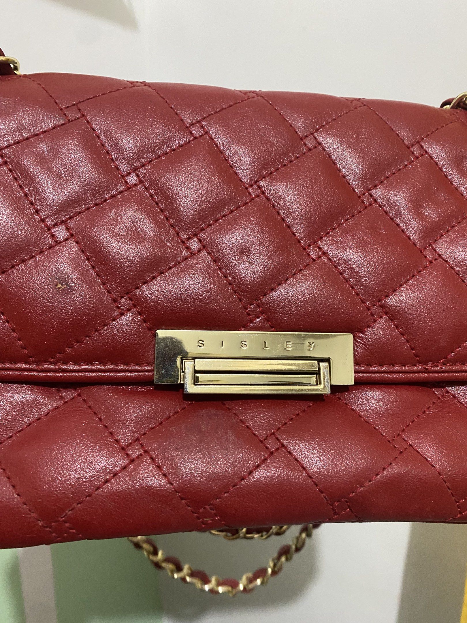 Sisley Red Quilted Shoulder Bag (Category: Shoulder Bags) located in Iloilo. Submitted by cja_apparel (Listing ID 1419525129, Image 2). Description: Flaw: Small pintok discoloration near the brand. Di halata. GENUINE LEATHER. Hardware: shining shimmering splendid! RFS: Going abroad. All must go!.