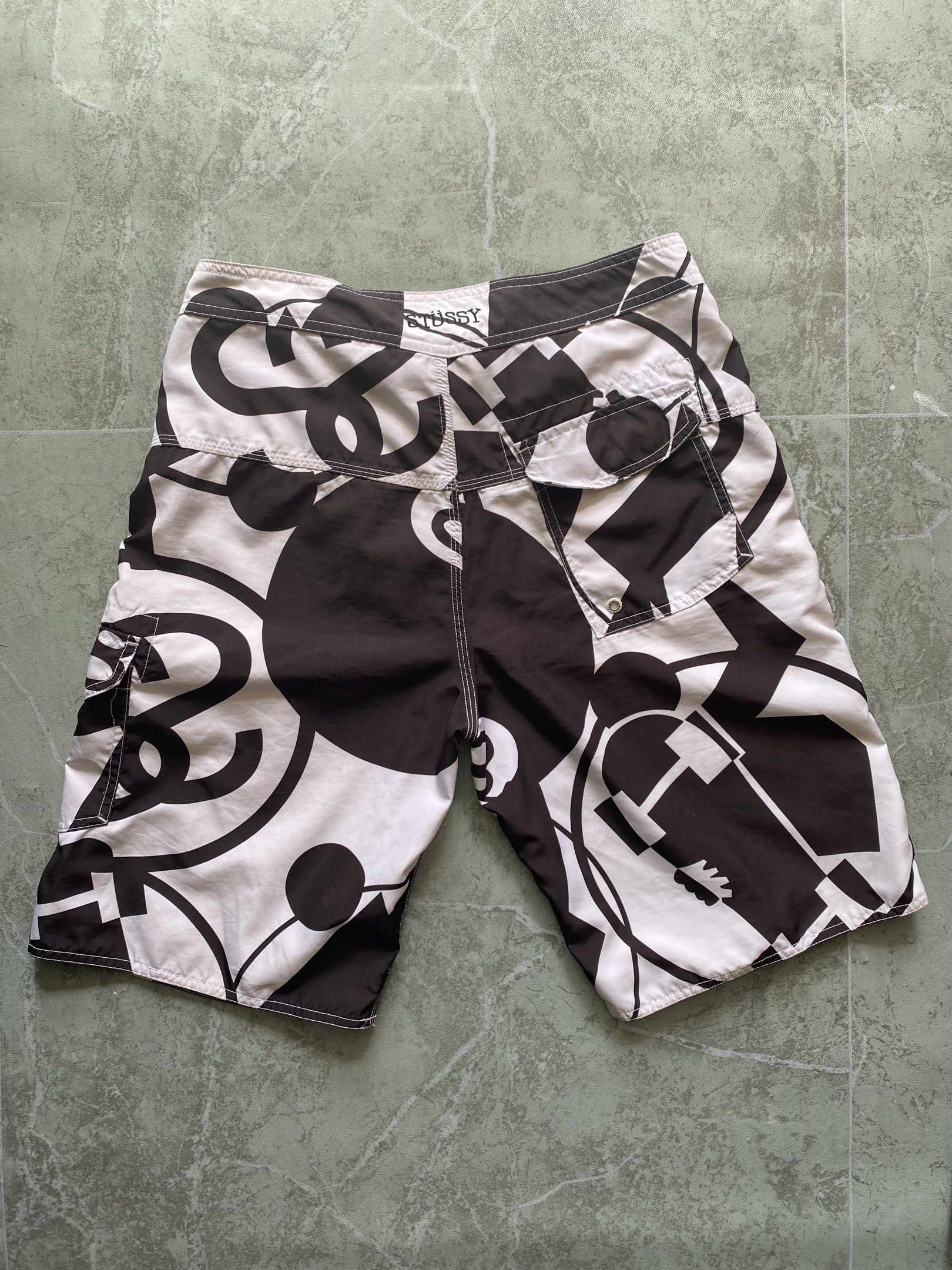 Stussy Black and White Beach Short (Category: Shorts) located in Santa Elena. Submitted by theycallmeeefred (Listing ID 1419405778, Image 2). Description: Stussy Black and White Swim Short Authentic / Legit Size: 30-32 (Waist) 21 (Length) Issue: Small black dot stain but not visible when wore .
