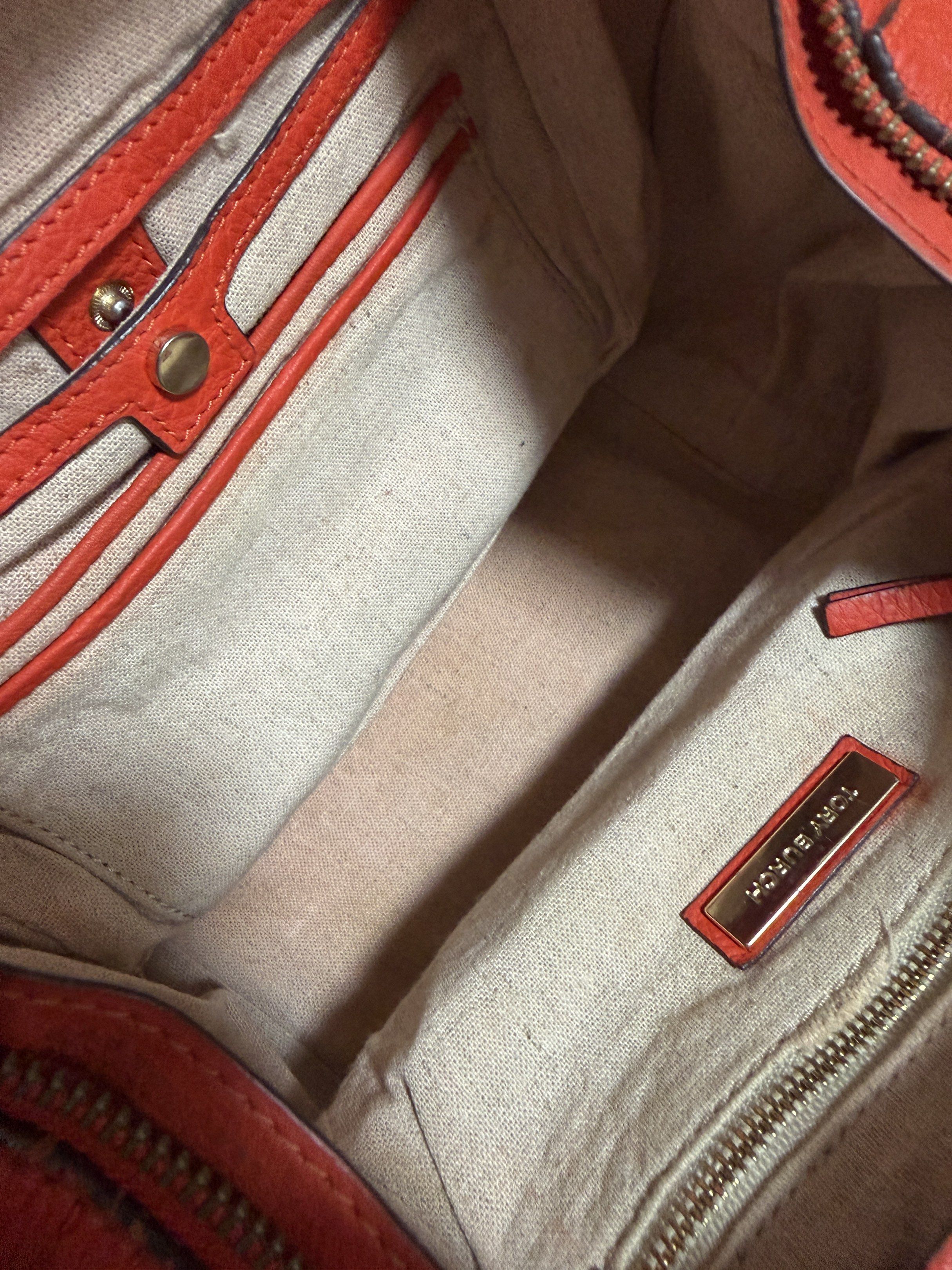 Tory Burch Leather Handbag (Category: Luxury Bags & Wallets) located in Mandaluyong City. Submitted by gee028 (Listing ID 1419487099, Image 1). Description: - Tory Burch handbag - Vibrant orange leather exterior - Flap closure with Tory Burch logo - Braided handle - Spacious interior - Includes small pocket and zipper closure - Made of high-quality leather.
