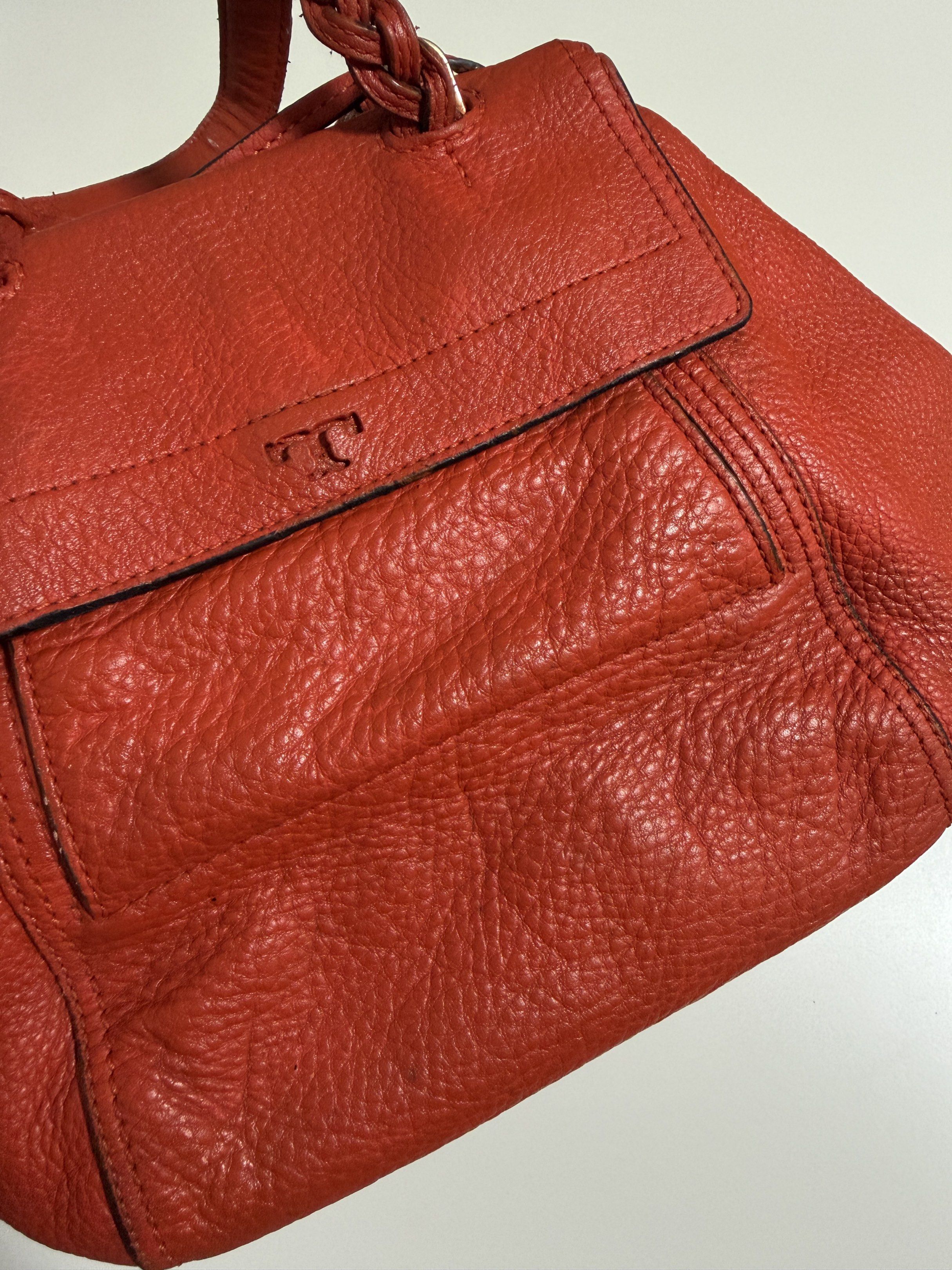 Tory Burch Leather Handbag (Category: Luxury Bags & Wallets) located in Mandaluyong City. Submitted by gee028 (Listing ID 1419487099, Image 3). Description: - Tory Burch handbag - Vibrant orange leather exterior - Flap closure with Tory Burch logo - Braided handle - Spacious interior - Includes small pocket and zipper closure - Made of high-quality leather.