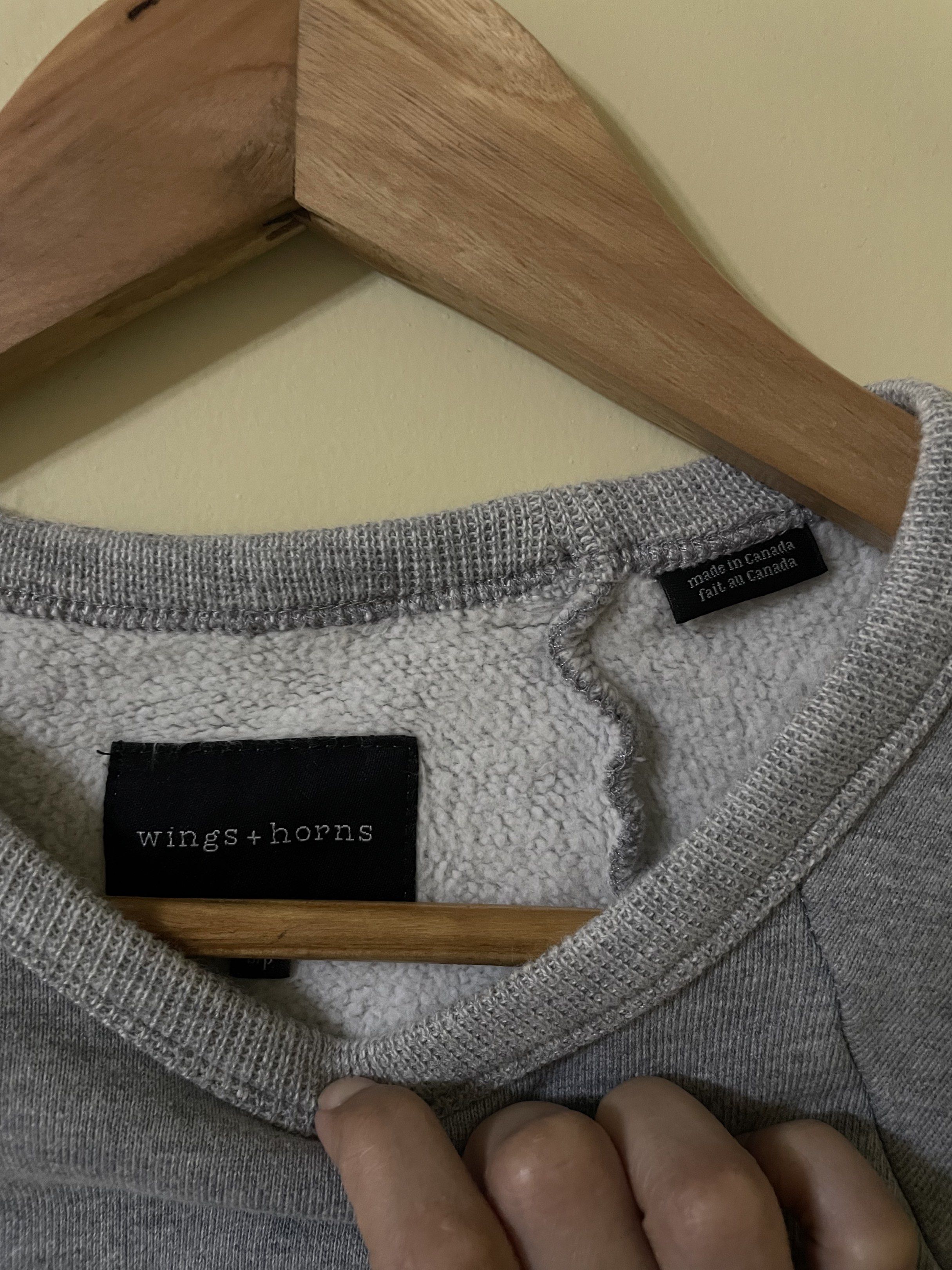 Wings + Horns Grey Sweatshirt (Category: Coats, Jackets and Outerwear) located in Laoag. Submitted by lovedbyyy (Listing ID 1419557039, Image 2). Description: - Grey Wings + Horns sweatshirt - Crew neck - Long sleeves with ribbed cuffs - Made in Canada - Relaxed fit - Mid-weight fabric - Suitable for cooler weather - Versatile for everyday wear.