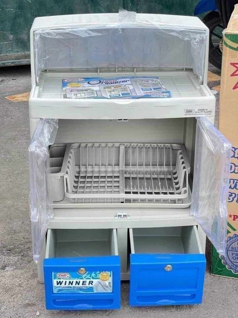 Zooey Winner Dish Cabinet (Category: Shelves, Cabinets & Racks) located in Makati City. Submitted by vsharon362 (Listing ID 1419414716, Image 3). Description: - Zooey Winner dish cabinet - Clear door - Two drawers - Top shelf for extra storage - Includes dish rack and utensil holder - Keeps dishes clean and organized - White and blue color scheme.