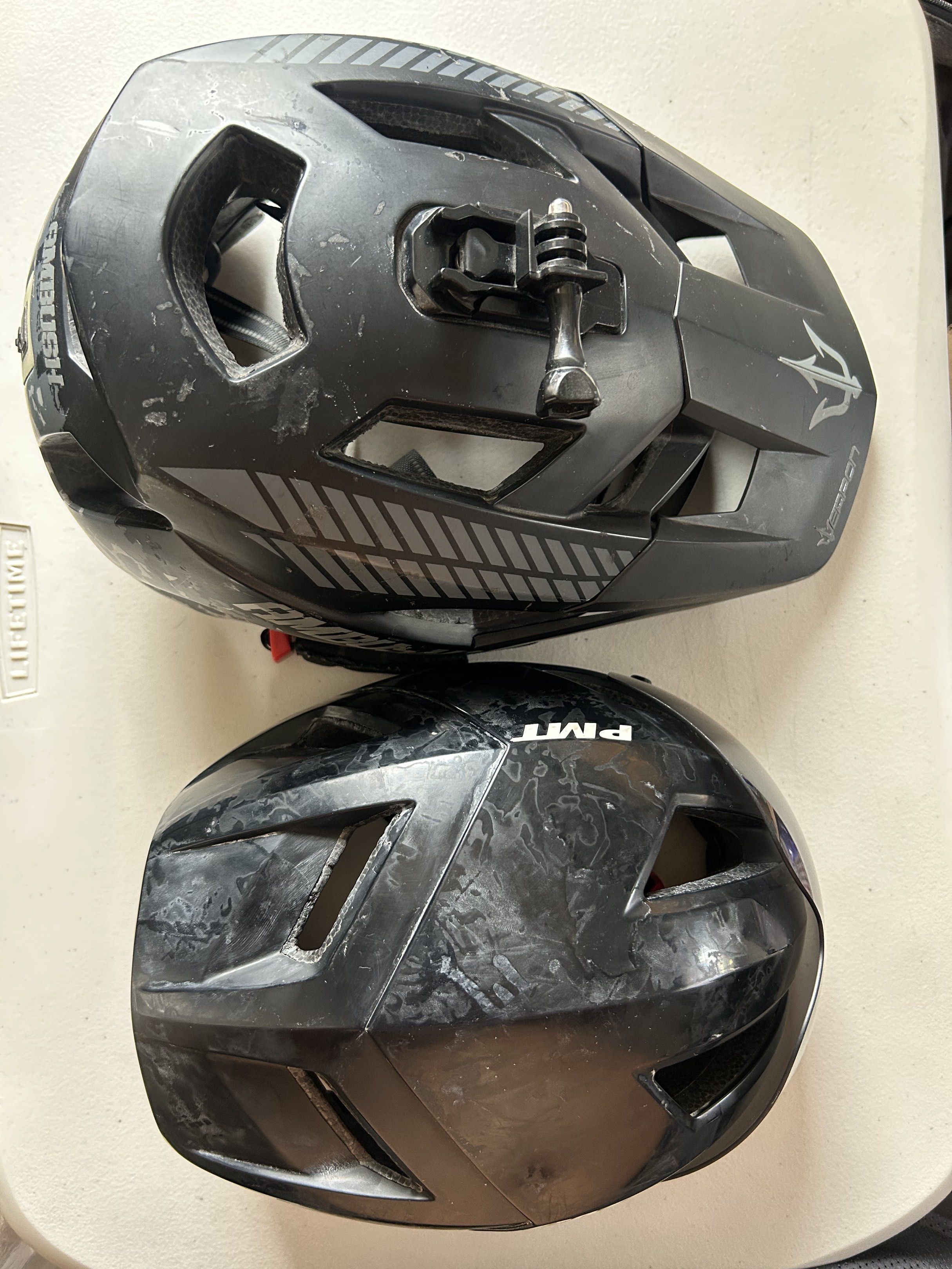 Ambush and PMT Bike Helmets (Category: Bicycles) located in Paranaque City. Submitted by keichi. (Listing ID 1419655250, Image 2). Description: 700 each or 1200 for both Signs of usage All useable Weapon helmet lights no issue with Go Pro mount PMT helmet with Visor Pick-up or Lalamove Parañaque loc - Two black bike helmets available. - Ambush helmet: - Black with camouflage detailing. - Includes GoPro mount. - PMT helmet: Black. - Interiors of b