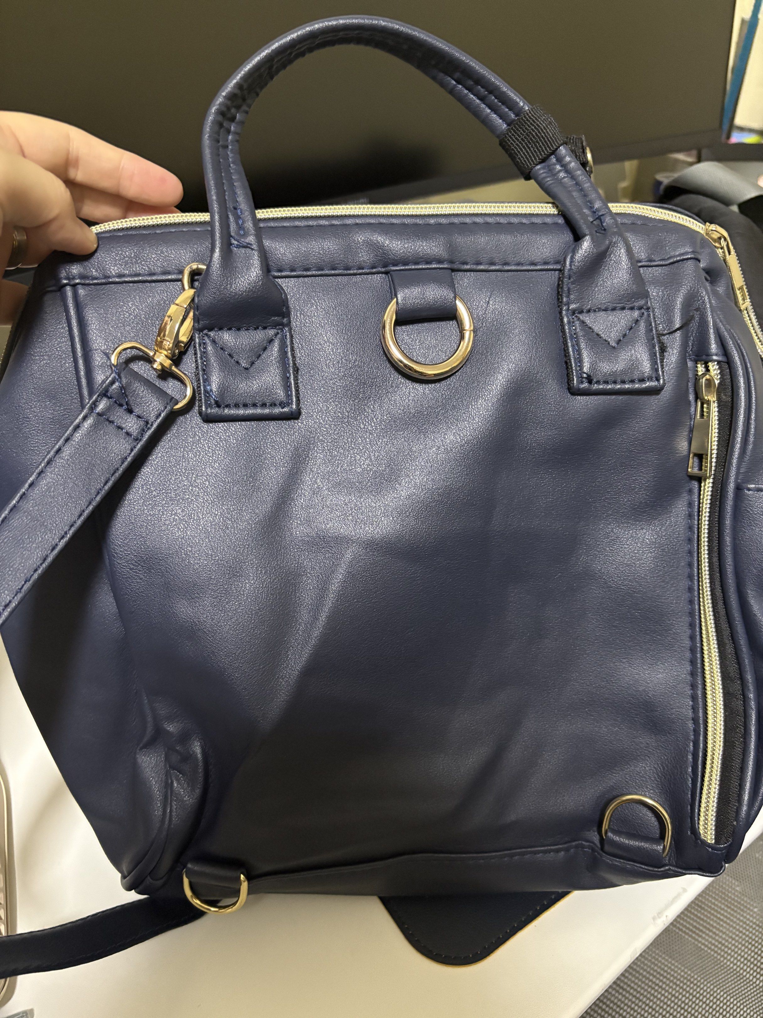 Anello 2-Way Mini Handbag - Navy Blue (Category: Cross-body Bags) located in Manila. Submitted by bearfruit (Listing ID 1419597462, Image 2). Description: - Anello 2-way mini handbag - Color: Navy Blue - Features: - Top handle - Detachable shoulder strap - Front zippered pocket - Side pockets - Gold-colored hardware - Main compartment zipper - Anello logo on front - Material: Leather-like.