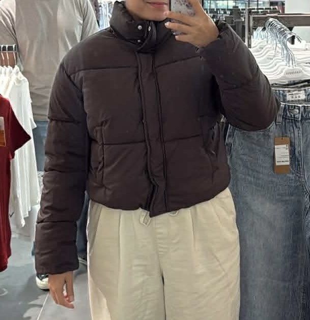 Brown Cropped Puffer Jacket (Category: Coats, Jackets and Outerwear) located in Manila. Submitted by pdee11 (Listing ID 1419672614, Image 3). Description: - Cropped puffer jacket - Solid brown color - High collar - Drawstring hem - Well-insulated - Versatile for various outfits - Perfect for cold weather.