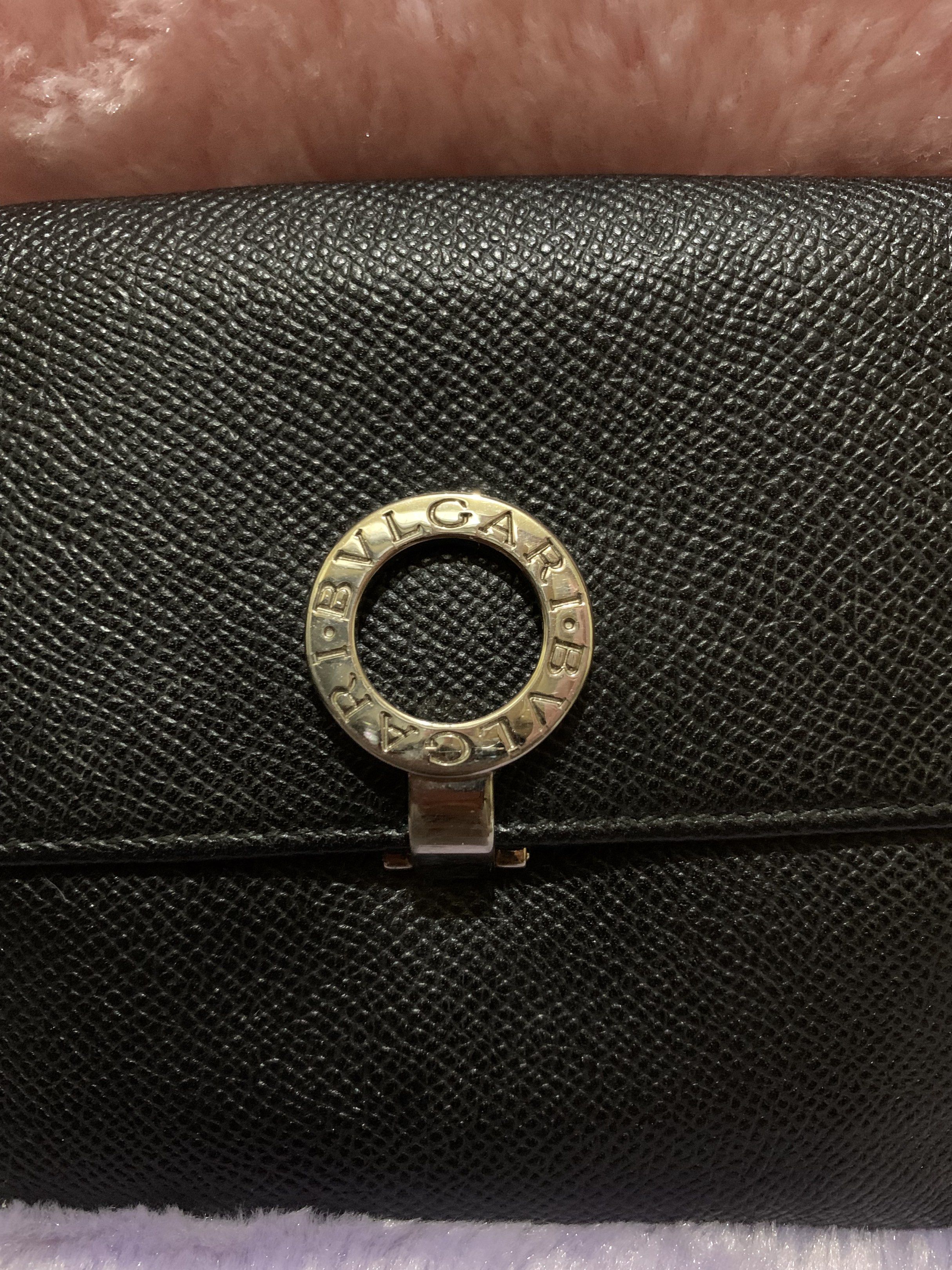 Bvlgari Black Leather Wallet (Category: Luxury Bags & Wallets) located in Quezon City. Submitted by ncjnc (Listing ID 1419716470, Image 2). Description: - Bvlgari black leather wallet - Silver-tone ring clasp closure - Multiple card slots - Bill compartment - Coin pocket - "BVLGARI MADE IN ITALY" embossed inside.