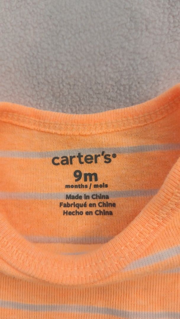 Carter's Orange Striped Onesie 9M (Category: Babies & Kids Fashion) located in Quezon City. Submitted by _itsmemarie_ (Listing ID 1419669779, Image 2). Description: - Carter's onesie - Size: 9 months - Color: Bright orange with light stripes - Features: Short sleeves, ribbed texture, snap closure at the bottom - Made in China.