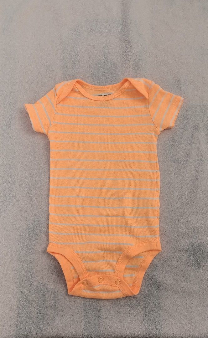 Carter's Orange Striped Onesie 9M (Category: Babies & Kids Fashion) located in Quezon City. Submitted by _itsmemarie_ (Listing ID 1419669779, Image 1). Description: - Carter's onesie - Size: 9 months - Color: Bright orange with light stripes - Features: Short sleeves, ribbed texture, snap closure at the bottom - Made in China.