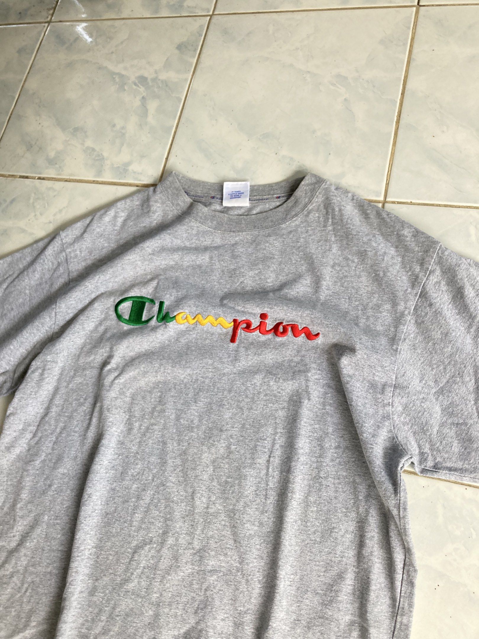 Champion Embroidered Logo T-shirt - Medium (Category: Tshirts & Polo Shirts ) located in Tarlac. Submitted by everthrift (Listing ID 1419776559, Image 2). Description: - Gray Champion t-shirt - Embroidered Champion logo (green, yellow, red) - Crew neck - Short sleeves - Size: Medium - Champion logo on sleeve - Made in USA .