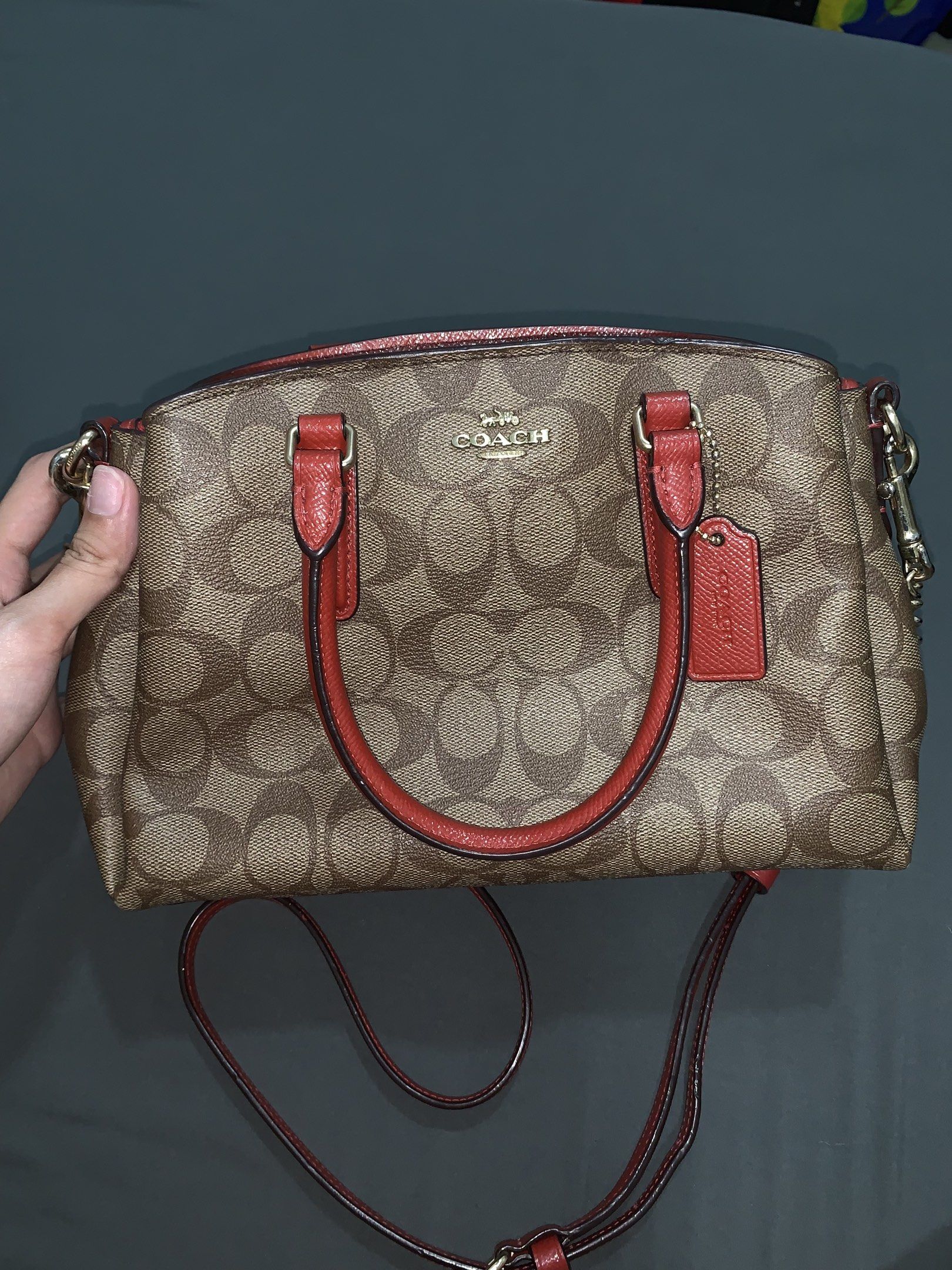 ‼️RUSH‼️Coach Canvas Monogram Mini Sage Carryall (Category: Luxury Bags & Wallets) located in Cagayan de Oro. Submitted by a11y4h (Listing ID 1419757512, Image 1). Description: - Coach Mini Satchel handbag - Signature print design - Red handles and detachable shoulder strap - Red interior - Includes Coach hangtag - Zip closure - Multiple compartments - Authentic Coach - Honest issue on the creed pm for pic. - Barely used. Only on occasions - Can 