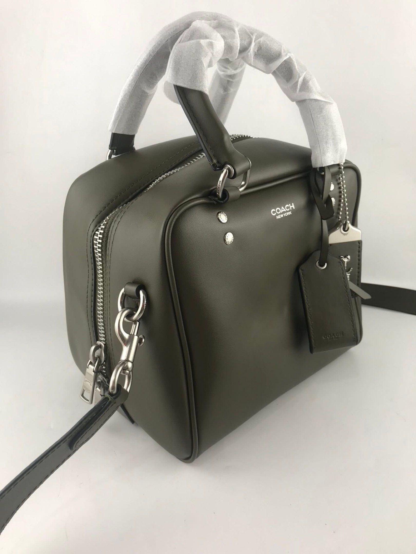 Coach Cube Rogue Bag 20 (Category: Cross-body Bags) located in Marikina City. Submitted by smthxtra (Listing ID 1419727310, Image 3). Description: Length: 8.0” Height: 7.0” Width: 7.0” Glazed leather Fabric lining Handles with 4” drop Detachable strap with 21.5” drop for shoulder or crossbody wear Outside zip pocket Inside zip pocket Zip closure Four protective feet at base With tag, care card, dust bag, and paper bag.