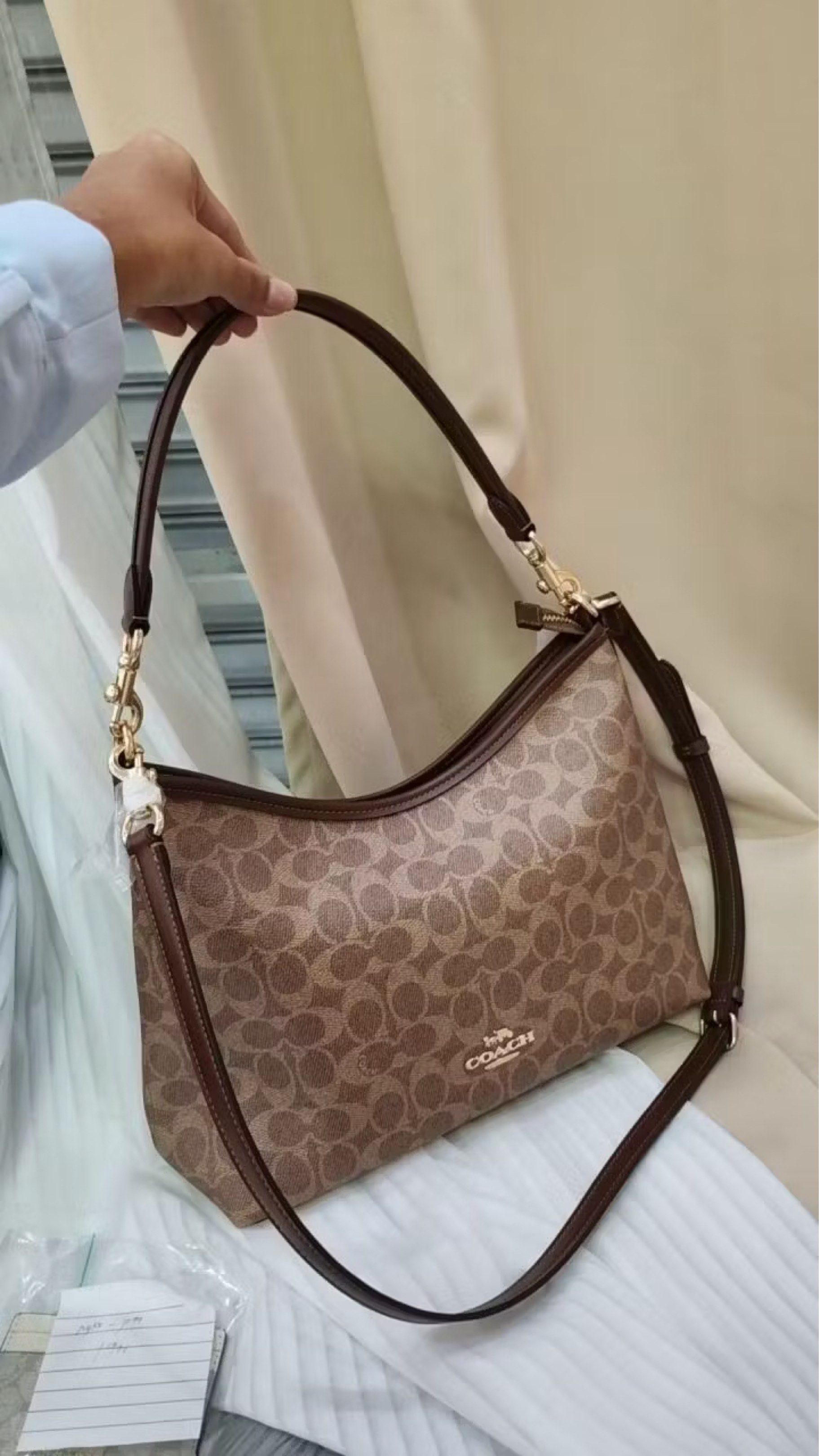 Coach Signature Shoulder Bag (Category: Luxury Bags & Wallets) located in Rodriguez. Submitted by nancyb13 (Listing ID 1419753848, Image 1). Description: - Authentic Coach shoulder bag - Features the classic Coach pattern - Includes two straps: short handle and adjustable long strap - Interior pocket - Made in the Philippines - Includes Coach tag and authenticity card.