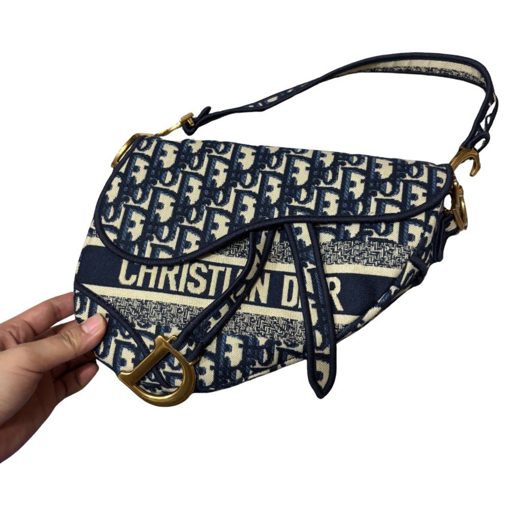 Dior Saddle Bag Oblique Jacquard (Category: Luxury Bags & Wallets) located in Bocaue. Submitted by parsimonybysf (Listing ID 1419614857, Image 1). Description: LAST PRICE (please dont haggle) - NGA Dior Saddle Bag - no box & dust bag hence selling low - Navy blue oblique jacquard - Gold-tone 'D' charm and hardware - Interior zipped pocket - Top handle and detachable shoulder strap rfs: badly need funds for school .