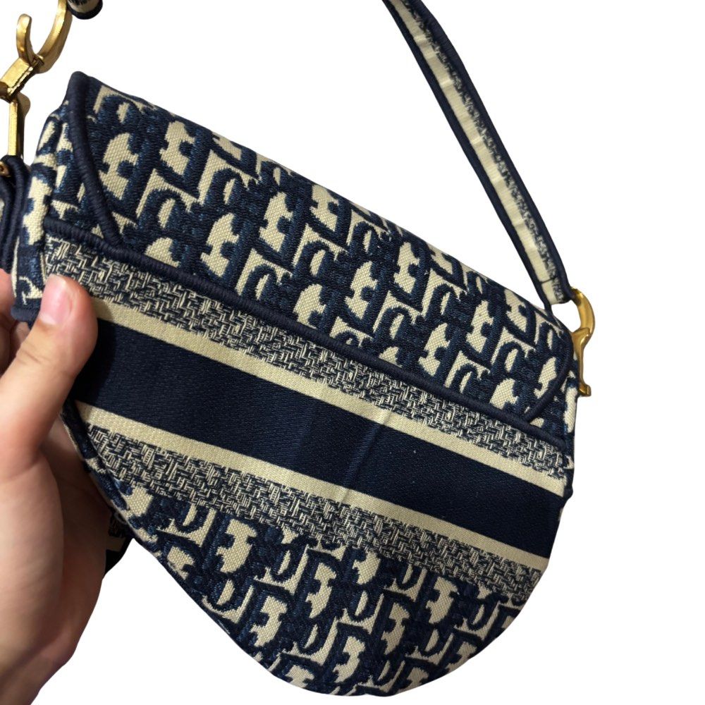 Dior Saddle Bag Oblique Jacquard (Category: Luxury Bags & Wallets) located in Bocaue. Submitted by parsimonybysf (Listing ID 1419614857, Image 3). Description: LAST PRICE (please dont haggle) - NGA Dior Saddle Bag - no box & dust bag hence selling low - Navy blue oblique jacquard - Gold-tone 'D' charm and hardware - Interior zipped pocket - Top handle and detachable shoulder strap rfs: badly need funds for school .