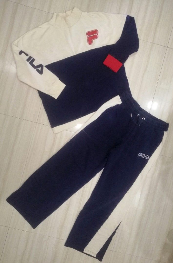 Fila Tracksuit Set - White and Navy (Category: Sets & Coordinates) located in Manila. Submitted by grovesthrift (Listing ID 1419704045, Image 1). Description: - Fila tracksuit set - Color: White and Navy Blue - UNiSEX - Size: M womens - Size: S mens - Top: Color-block design, Fila logo on chest and sleeve - Pants: White stripe detail, Fila logo on left leg - Made in China.