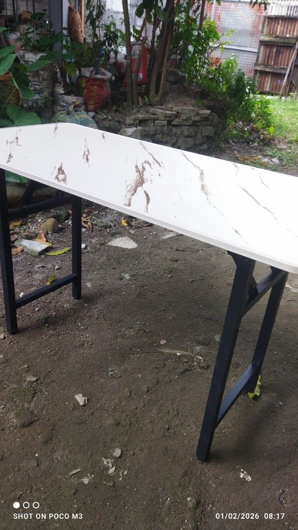 Folding Table with Marble Top (Category: Tables & Sets) located in Manila. Submitted by money-lyn (Listing ID 1419702455, Image 3). Description: 120x60 Folding table with a white marble-patterned top and black metal legs. The table is rectangular with rounded corners. The legs fold for easy storage. Perfect for small spaces or temporary setups..