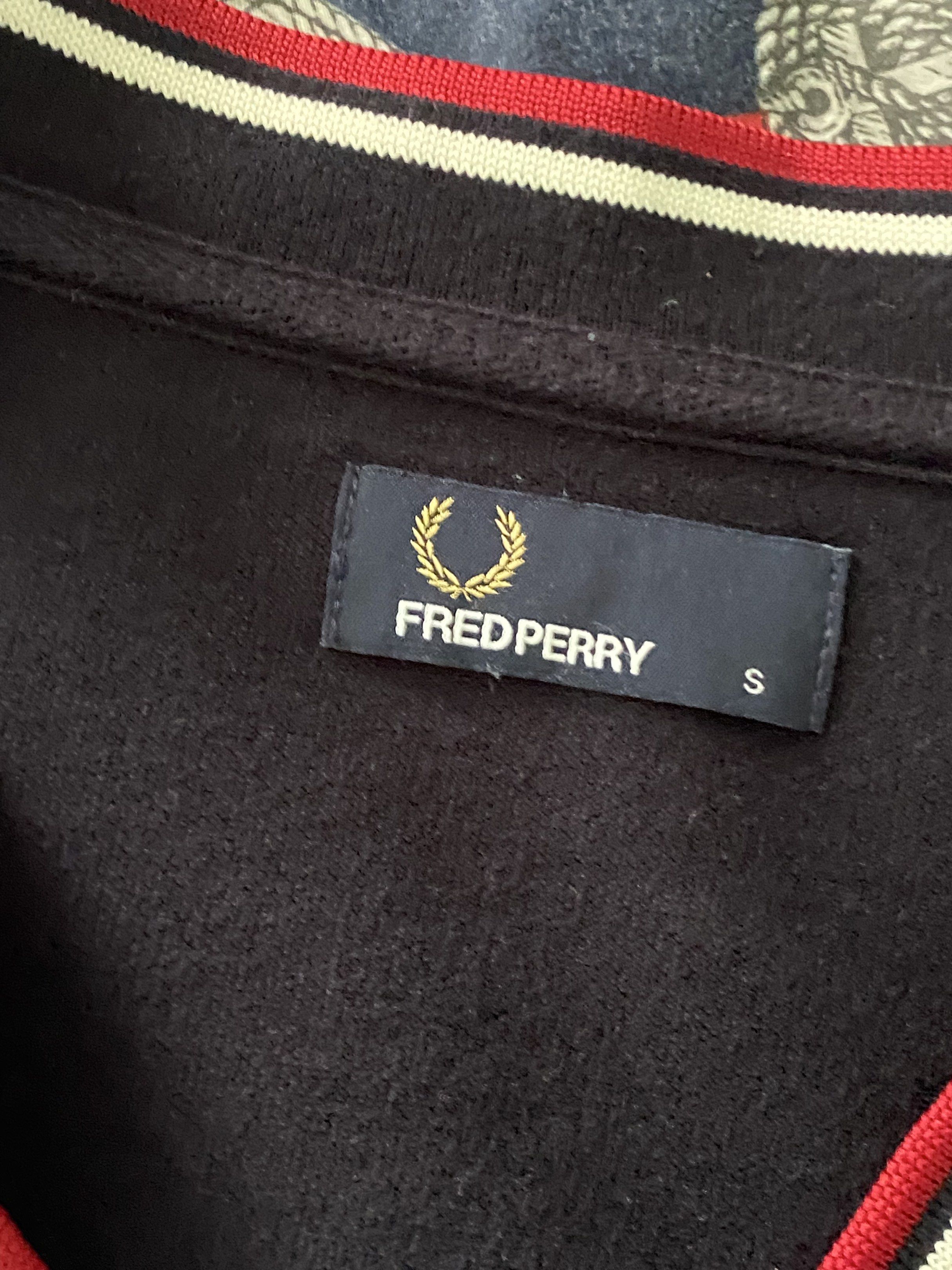 Fred Perry Cardigan - Navy Blue (Category: Coats, Jackets and Outerwear) located in Cebu City. Submitted by bred_bt (Listing ID 1419678223, Image 2). Description: - Fred Perry navy blue cardigan - Size: Small - Features: - V-neck with red and white stripes - Embroidered Fred Perry logo - Button-up front - Long sleeves.