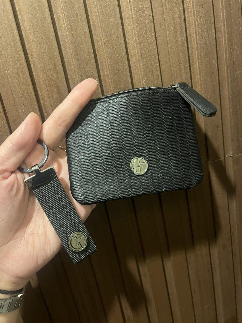 Giorgio Armani Key Pouch and Keychain Set (Category: Luxury Bags & Wallets) located in Paranaque City. Submitted by bagbrained88 (Listing ID 1419650999, Image 1). Description: - Black key pouch and keychain set. - Zippered pouch with a small logo. - Keychain with fabric strap and metal logo emblem. - Made of a textured material. - Perfect for keys and small essentials. - Compact and easy to carry..