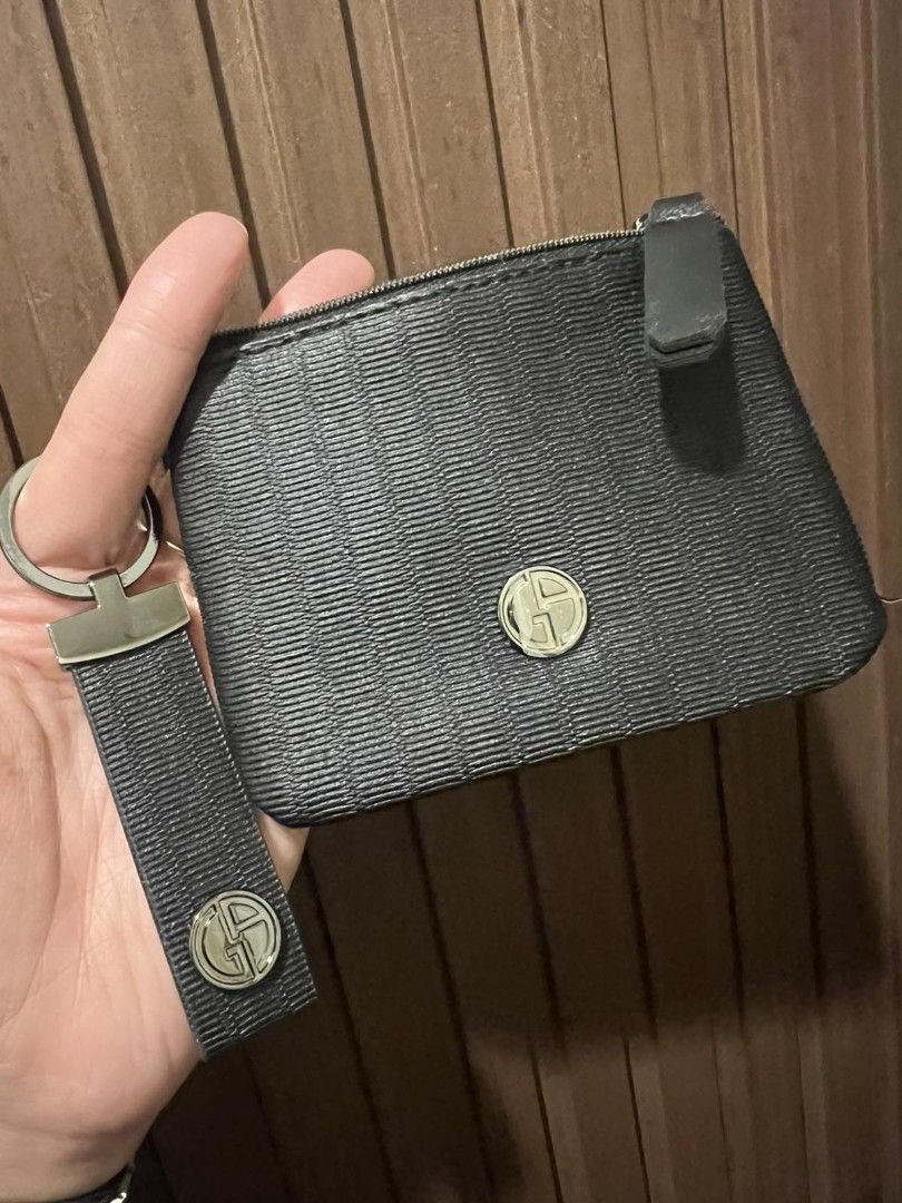 Giorgio Armani Key Pouch and Keychain Set (Category: Luxury Bags & Wallets) located in Paranaque City. Submitted by bagbrained88 (Listing ID 1419650999, Image 2). Description: - Black key pouch and keychain set. - Zippered pouch with a small logo. - Keychain with fabric strap and metal logo emblem. - Made of a textured material. - Perfect for keys and small essentials. - Compact and easy to carry..