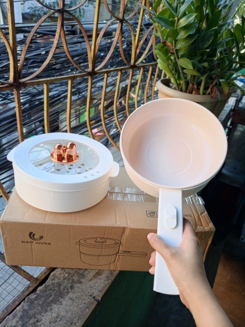 Han River Electric Steaming Cooking Pot (Category: Cookware & Accessories) located in Quezon City. Submitted by ajonlinesh55809 (Listing ID 1419619309, Image 1). Description: Han River electric cooking pot is perfect for steaming and cooking. It features a non-stick pot and a steamer. The pot has a detachable handle for easy storage. The set includes a transparent lid with a rose gold accent. It comes with its original box..