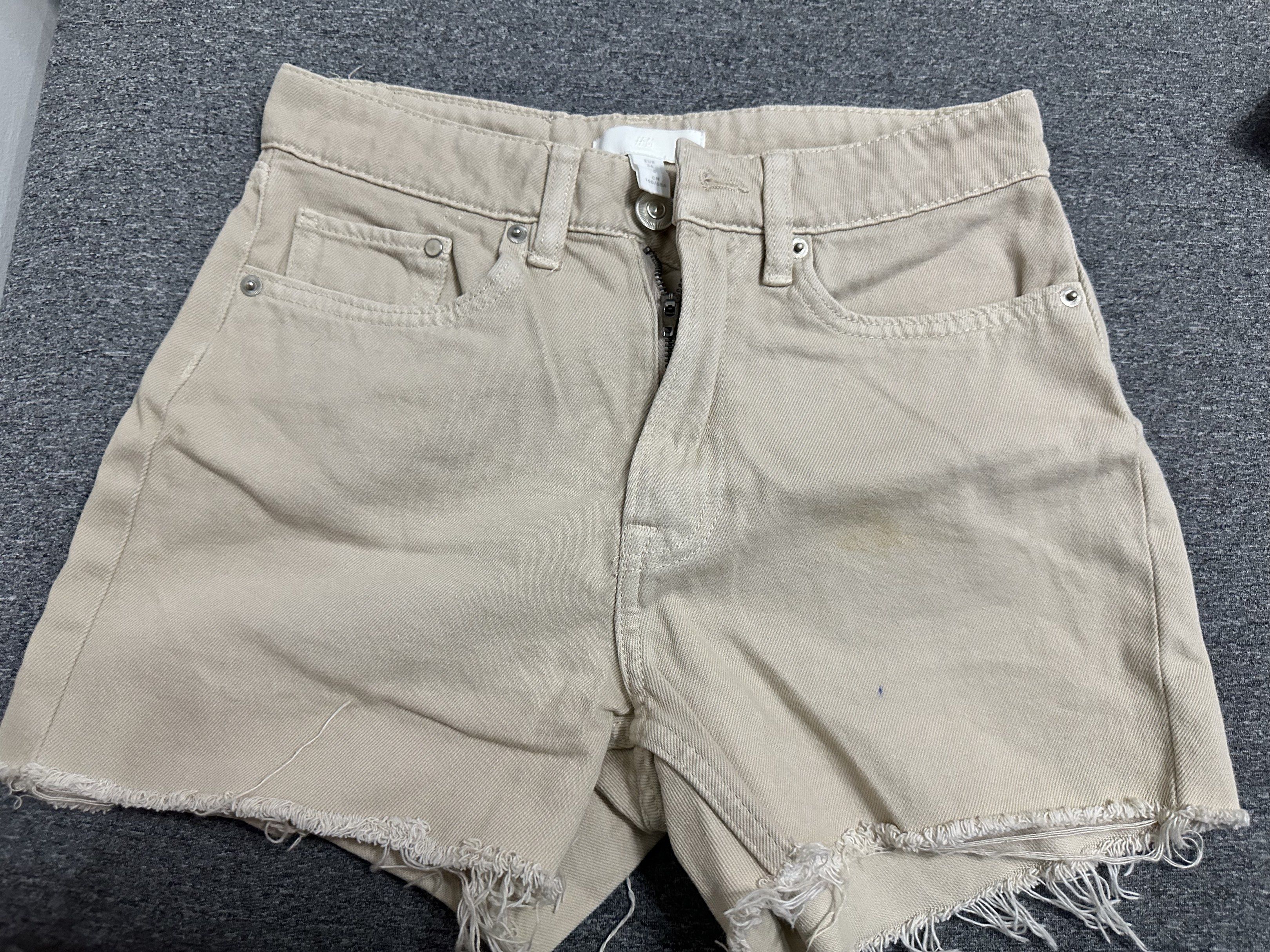 H&M Beige Denim Shorts (Category: Shorts) located in Manila. Submitted by ryryrys (Listing ID 1419658100, Image 1). Description: - H&M beige denim shorts - Size: EUR 36 - Features: - High-waisted fit - Raw hem - Five-pocket design - Zip fly and button closure - Perfect for casual wear.