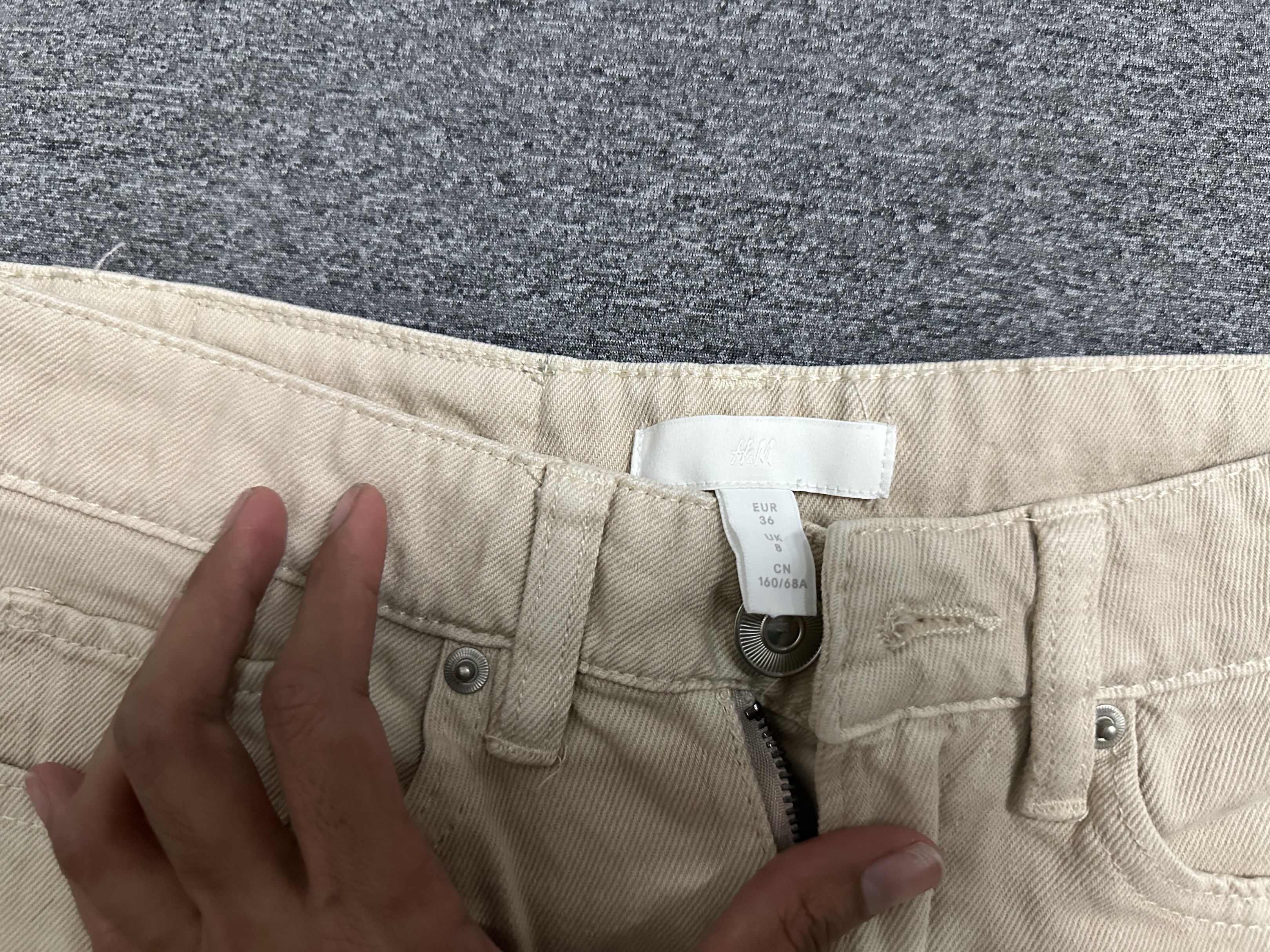 H&M Beige Denim Shorts (Category: Shorts) located in Manila. Submitted by ryryrys (Listing ID 1419658100, Image 2). Description: - H&M beige denim shorts - Size: EUR 36 - Features: - High-waisted fit - Raw hem - Five-pocket design - Zip fly and button closure - Perfect for casual wear.
