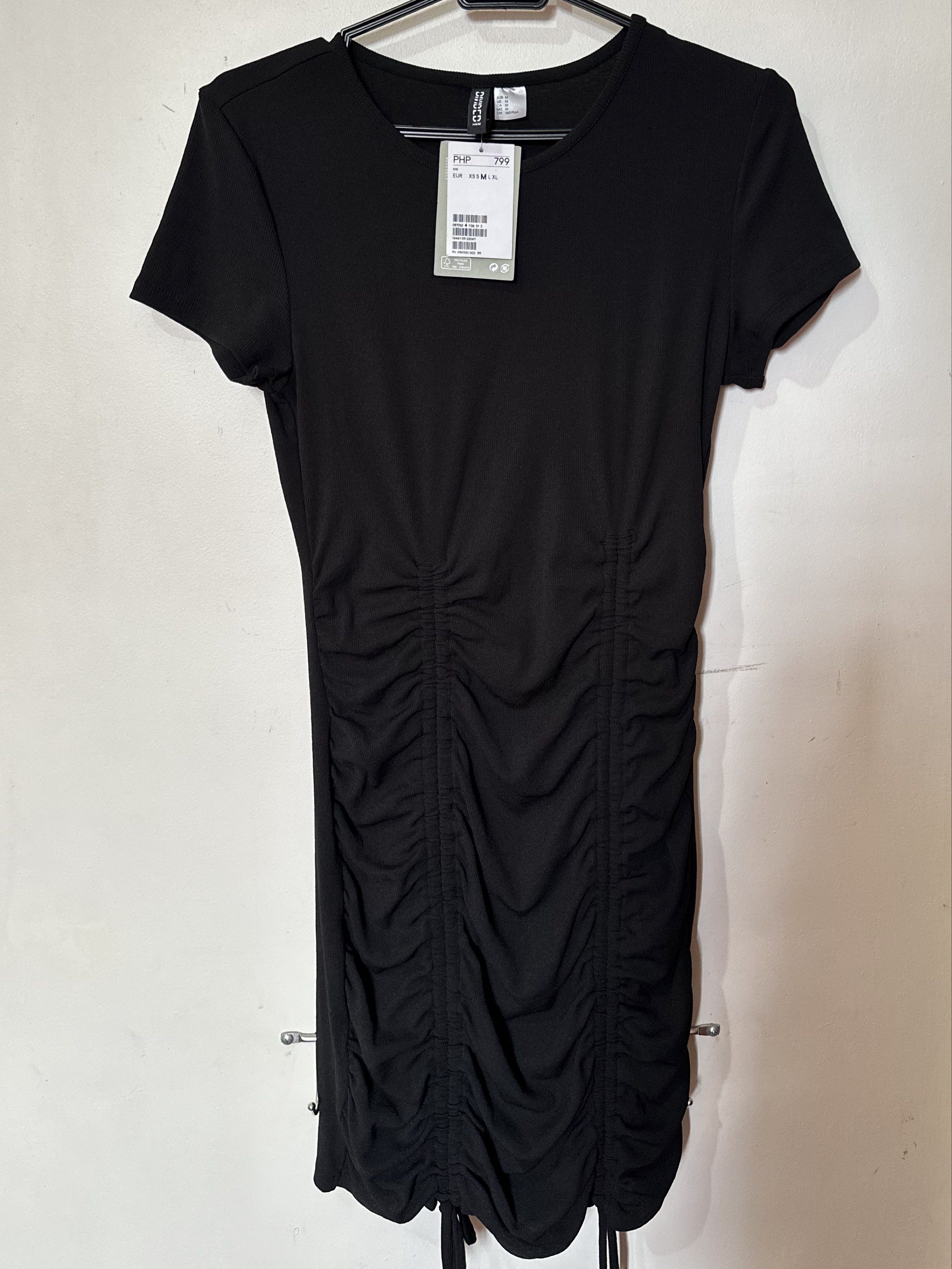 H&M Divided Black Ruched Dress (Category: Dresses) located in Manila. Submitted by jfrancesg (Listing ID 1419651740, Image 2). Description: - original price: ₱799 - ruched detailing - adjustable ties at hem - stretchable fabric notes - never worn outside, only fitted - DM for more pics/ vids mop: gcash/ bpi mod: ggx/ sdd within manila/ meetup (SM north).