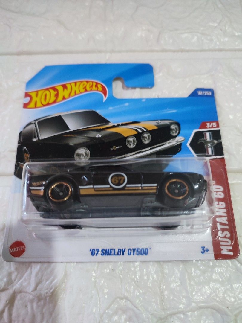 Hot Wheels '67 Shelby GT500 (Category: Vehicle & Diecast Models) located in Narvacan. Submitted by jigger85 (Listing ID 1419679073, Image 1). Description: - Hot Wheels '67 Shelby GT500 - Black body with gold and white stripes - Gold rims - Part of the Mustang 60 series (3/5) - Features the Hot Wheels logo.