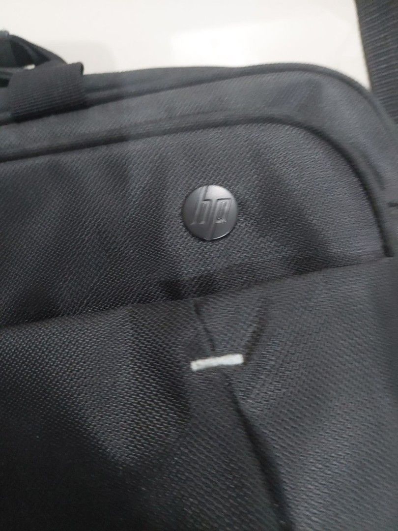 HP Laptop Bag with Shoulder Strap (Category: Laptop Bags & Sleeves) located in Mandaluyong City. Submitted by derekalava (Listing ID 1419757851, Image 2). Description: - Black HP laptop bag - Includes shoulder strap and handle - Multiple compartments for storage - Padded section for laptop protection - Features HP logo - Secure zipper closure - Made of durable material.