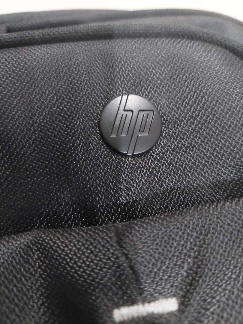 HP Laptop Bag with Shoulder Strap (Category: Laptop Bags & Sleeves) located in Mandaluyong City. Submitted by derekalava (Listing ID 1419757851, Image 3). Description: - Black HP laptop bag - Includes shoulder strap and handle - Multiple compartments for storage - Padded section for laptop protection - Features HP logo - Secure zipper closure - Made of durable material.