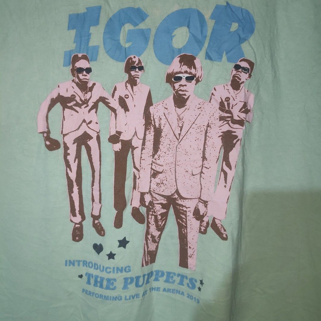 Igor The Puppets T-Shirt (Category: Tshirts & Polo Shirts ) located in Masbate. Submitted by ydruattacks (Listing ID 1419751159, Image 3). Description: - Igor T-shirt - Features "The Puppets" design - Color: Light Green - Size: Medium - Material: 100% Cotton - Neckline: Crew Neck - Sleeve Length: Short Sleeves - Made in Mexico by Golf Wang - 20W x 27L - Issue: Bleach stain on front part.