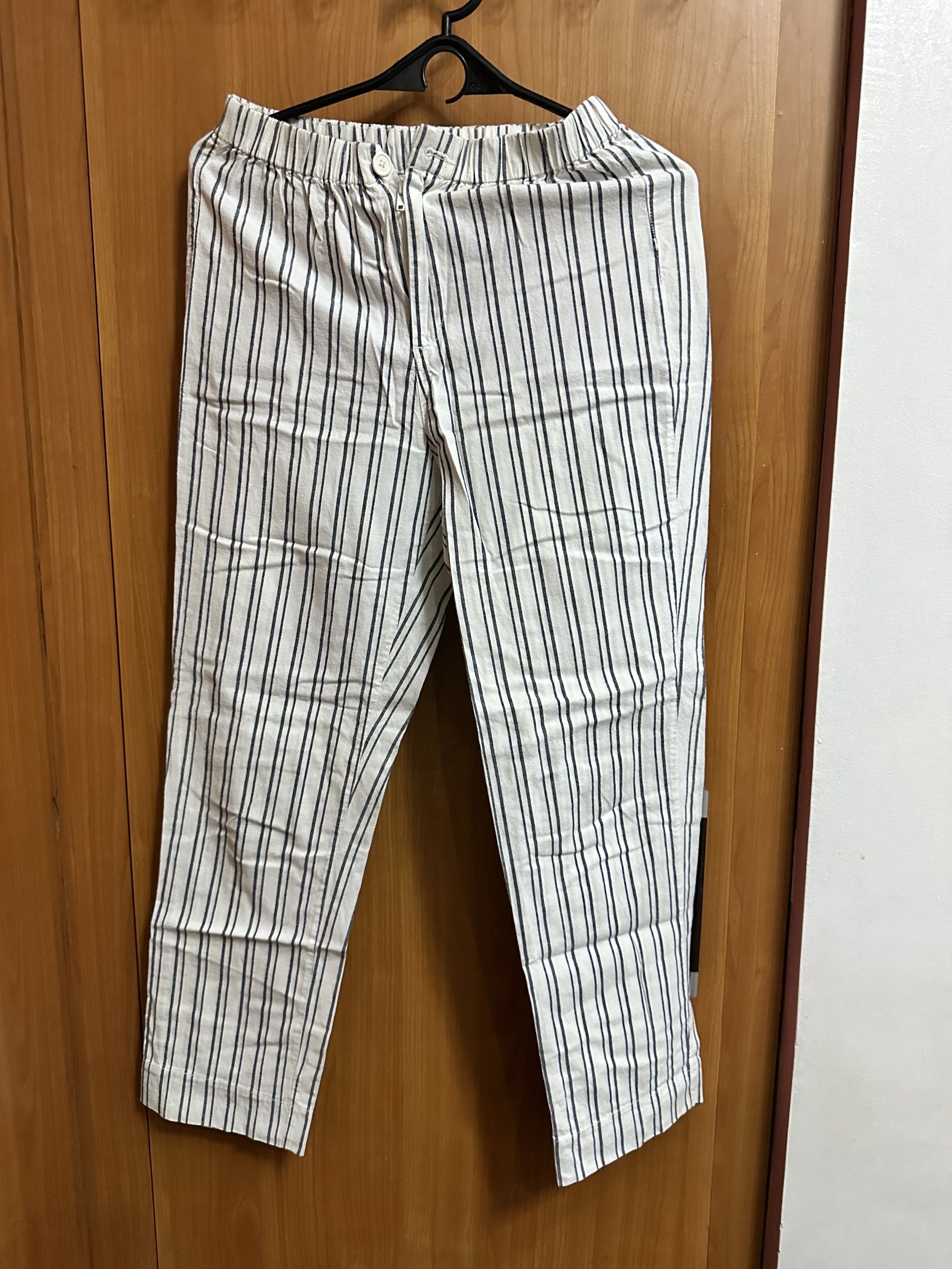 Jgalt pants (Category: Other Bottoms) located in Manila. Submitted by ryryrys (Listing ID 1419637888, Image 1). Description: - White pants with vertical black stripes - Elastic waistband with button closure - Lightweight fabric - Straight leg cut - Ideal for casual wear.