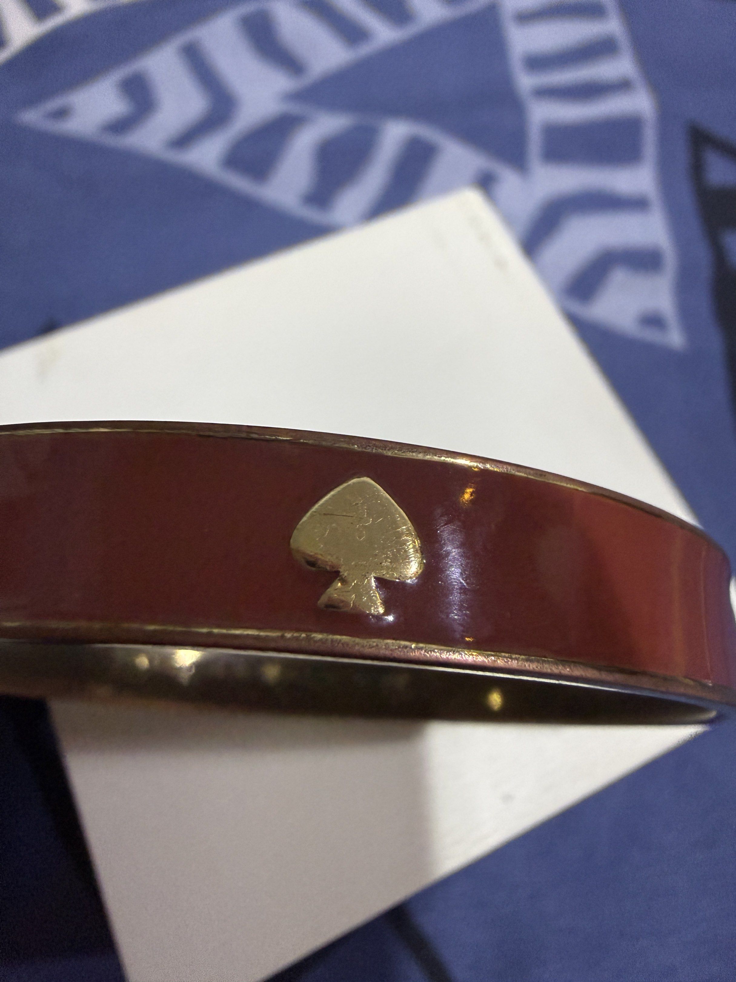 Kate Spade New York Bangle Bracelet (Category: Bracelets) located in Manila. Submitted by lbiliran1346900 (Listing ID 1419712074, Image 2). Description: - Kate Spade New York bangle bracelet - Reddish-brown enamel finish - Gold-tone hardware - Kate Spade New York logo engraved inside - Spade details - Classic design - Great accessory for any outfit.