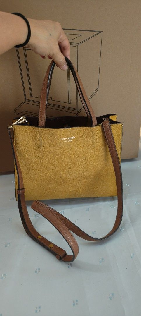 Kate Spade Yellow Handbag with Brown Straps (Category: Luxury Bags & Wallets) located in Bulacan. Submitted by machika (Listing ID 1419664809, Image 1). Description: - Limited Edition - Kate Spade handbag - Vibrant yellow exterior - Brown straps - Top handle and detachable shoulder strap - Rectangular shape - Textured material - Black interior - Kate Spade logo on front.