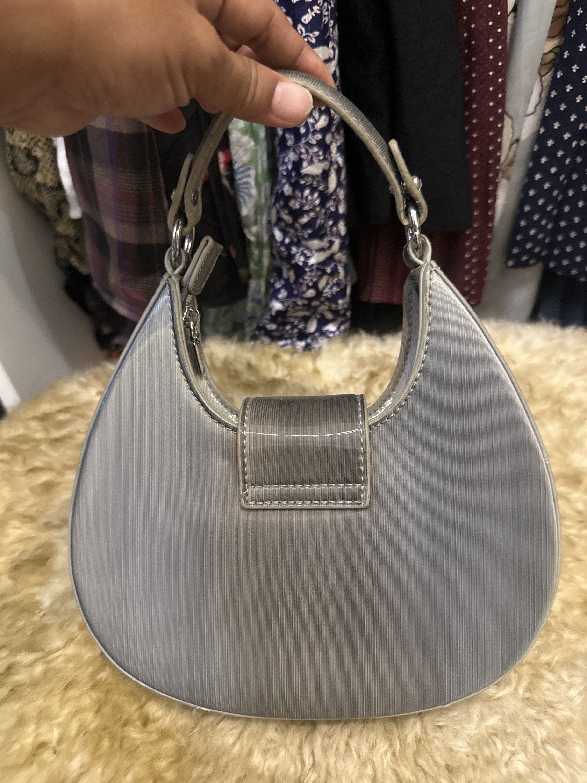 Kelly Toyboy Silver Handbag (Category: Luxury Bags & Wallets) located in Digos. Submitted by puremountain.6f1756 (Listing ID 1419640289, Image 2). Description: - Silver handbag - Brand: Kelly Toyboy - Unique shape - Top handle - Silver clasp closure - Textured surface - Interior pocket - Dimensions: Approximately 20cm (H) x 22cm (W) Note: bawal sa maarte , I am selling my collection to support my daughter. I am single mom. .
