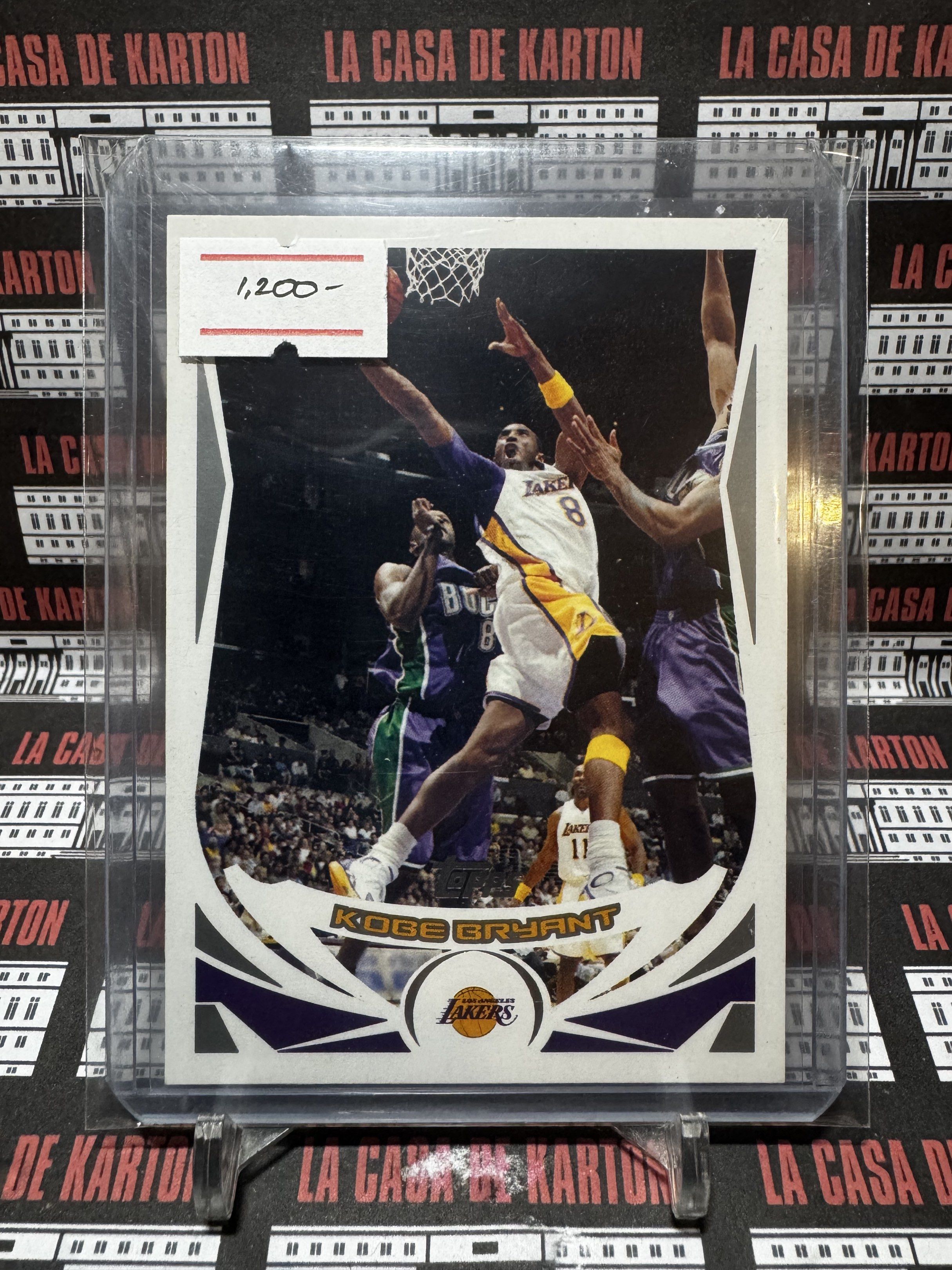 Kobe Bryant Lakers Trading Card (Category: Raw Singles) located in Pateros City. Submitted by lacasadekartonph (Listing ID 1419647344, Image 1). Description: - Kobe Bryant Lakers trading card - Features Kobe in his Lakers uniform - Shows Kobe going for a dunk - Includes the Lakers logo - Protected in a sleeve - Price: ₱1,200.