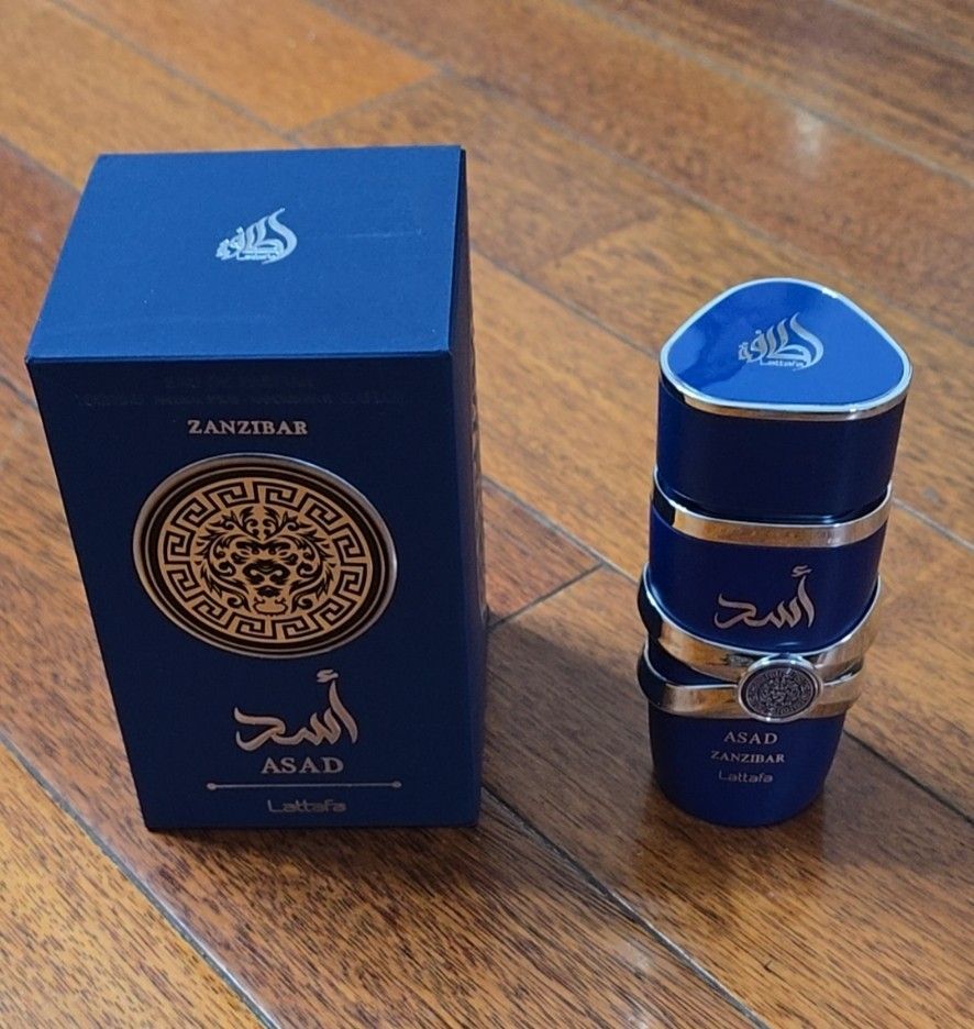 Lattafa Asad Zanzibar Perfume (Category: Fragrance & Deodorants) located in Pasay City. Submitted by jd.glamourish (Listing ID 1419774172, Image 1). Description: - Lattafa Asad Zanzibar perfume. - Distinctive bottle design with a silver band. - Elegant box with blue, gold, and silver accents. - Features the word "Zanzibar" on the box. - Name written in English and Arabic. 💯authentic .