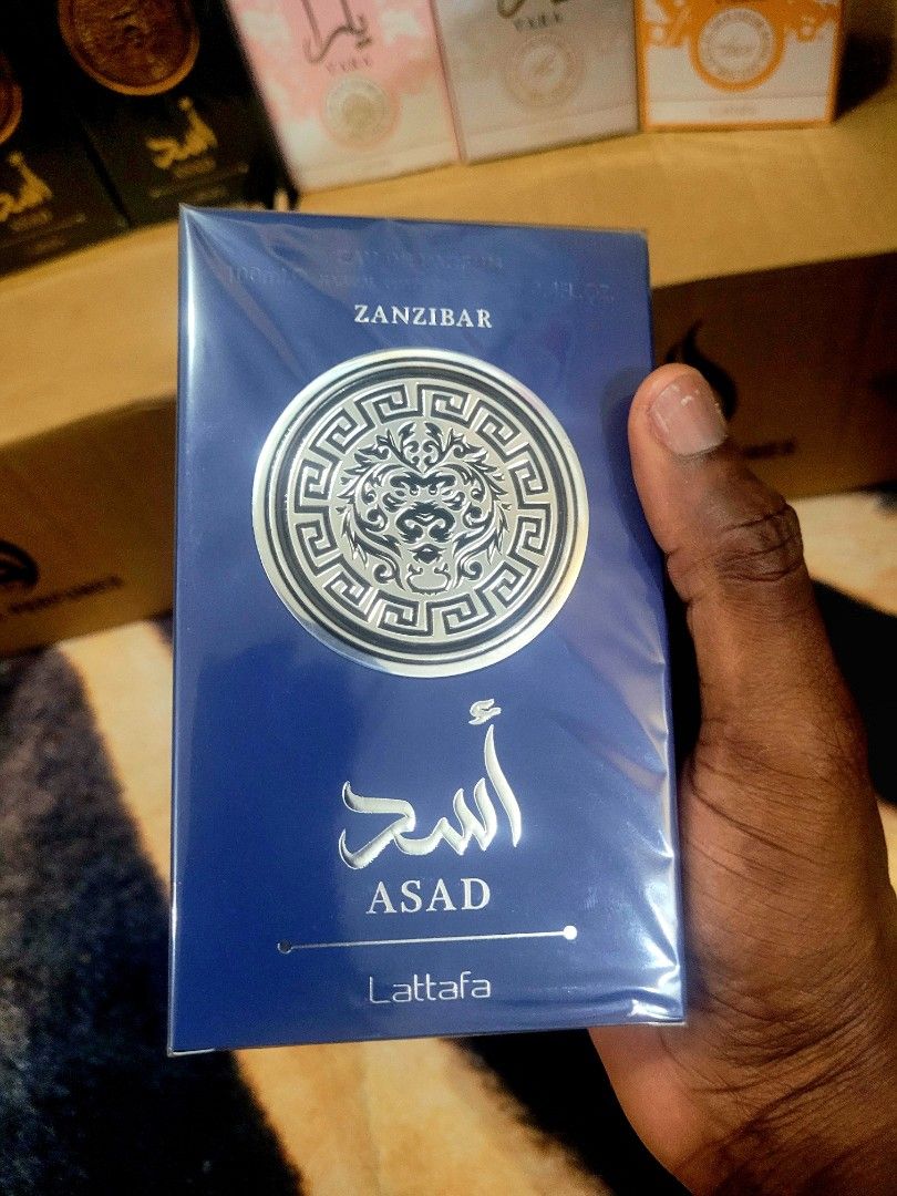 Lattafa Asad Zanzibar Perfume (Category: Fragrance & Deodorants) located in Pasay City. Submitted by jd.glamourish (Listing ID 1419774172, Image 3). Description: - Lattafa Asad Zanzibar perfume. - Distinctive bottle design with a silver band. - Elegant box with blue, gold, and silver accents. - Features the word "Zanzibar" on the box. - Name written in English and Arabic. 💯authentic .