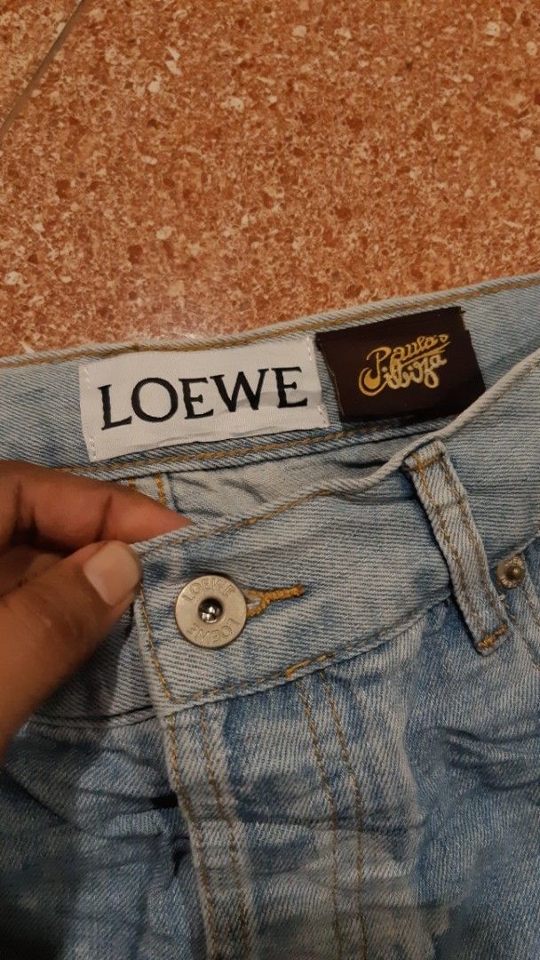 Loewe Fish-Print Denim Shorts (Category: Shorts) located in Malaybalay. Submitted by rielstuff (Listing ID 1419724406, Image 2). Description: - Loewe denim shorts - Unique fish print design - High-rise waist - Frayed hem - Button closure - Classic five-pocket styling - Loewe logo detail - Light blue wash - White fish print.