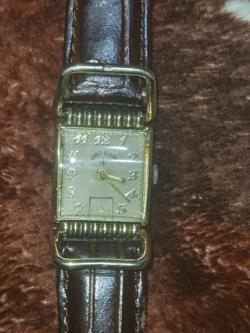 Lord Elgin Vintage Watch (Category: Men's Watches) located in Caloocan City. Submitted by lux_sellier (Listing ID 1419770527, Image 2). Description: - Vintage Lord Elgin watch - Rectangular gold-toned face - Brown leather strap - Buckle closure - Strap marked "Genuine Leather" - Strap marked "Italy" - Displays brand name and hour markers Price NEGOTIABLE.