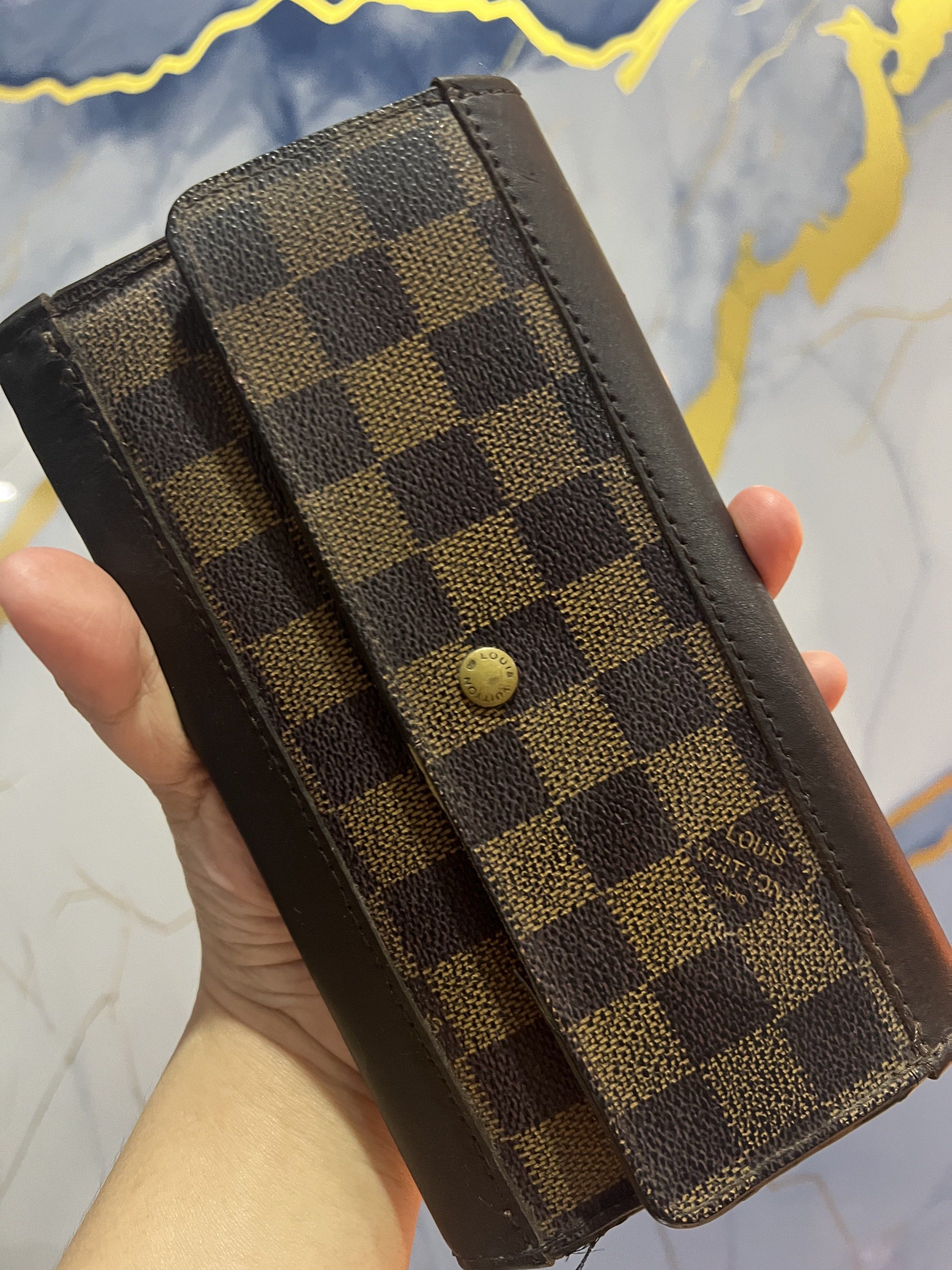 Louis Vuitton Damier Ebene Wallet Authentic (Category: Luxury Bags & Wallets) located in Bulacan. Submitted by gcdeclutters_malolosbulacan (Listing ID 1419612002, Image 1). Description: - Authentic Louis Vuitton Damier Ebene wallet - Project - As Is Where Is - Edges repaired with original vachetta leather - Iconic Damier Ebene canvas exterior - Brown leather trim - Multiple card slots and compartments - Snap closure - Brown textile interior linin